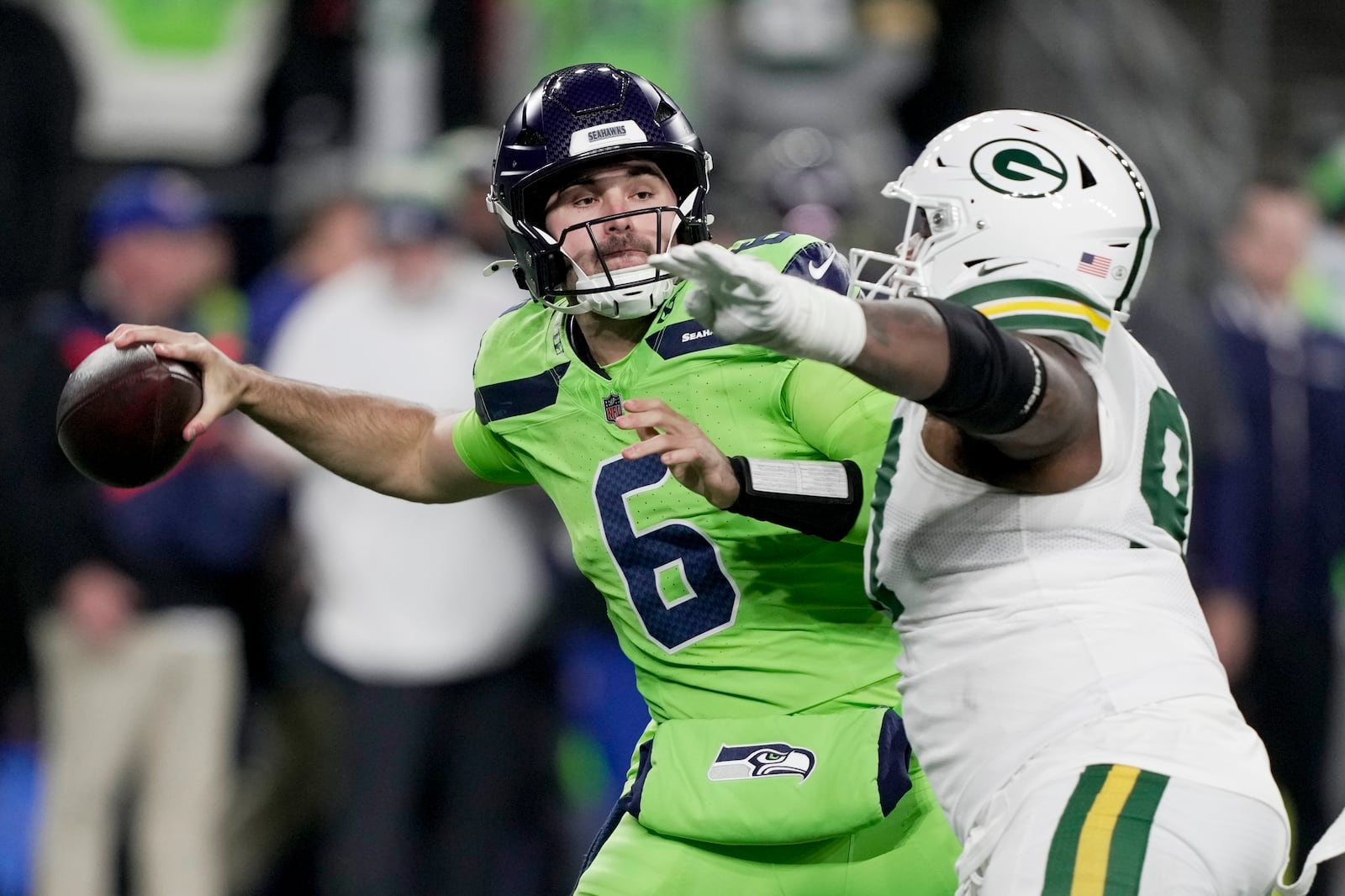 Seattle Seahawks' Sam Howell is pressured by Green Bay Packers' Kenny Clark during the second half of an NFL football game Sunday, Dec. 15, 2024, in Seattle. (AP Photo/Stephen Brashear)