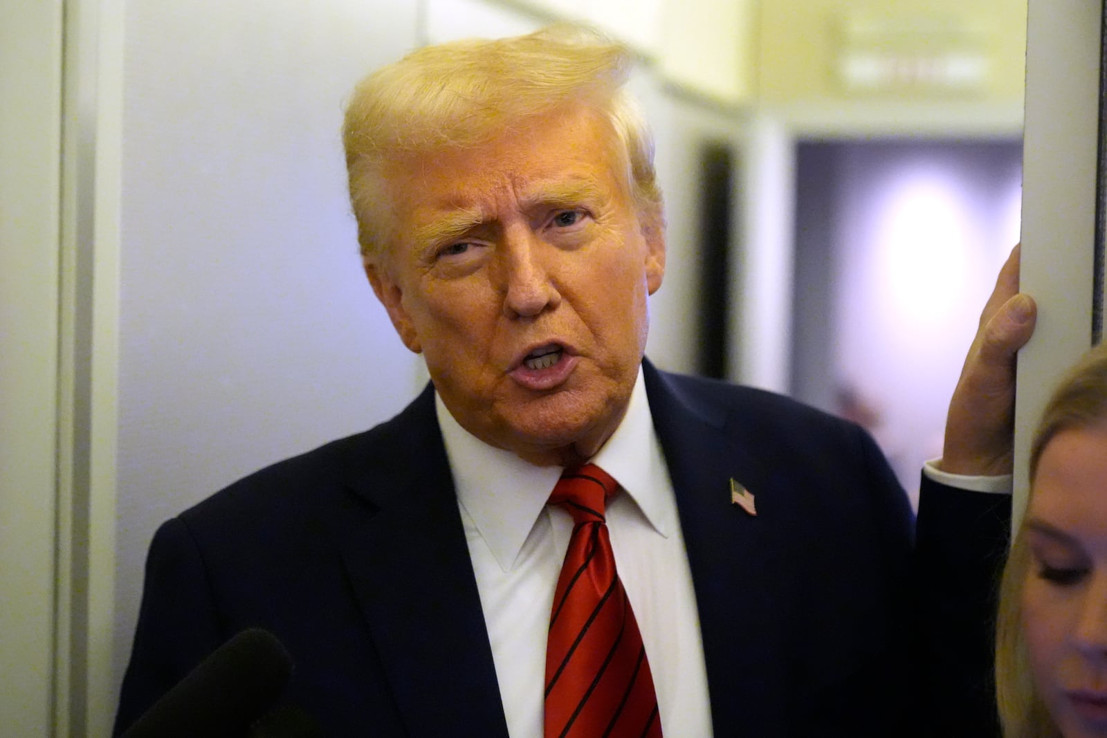 President Donald Trump speaks to reporters aboard Air Force One en route from Miami to Joint Base Andrews, Md., Monday, Jan. 27, 2025. (AP Photo/Mark Schiefelbein)