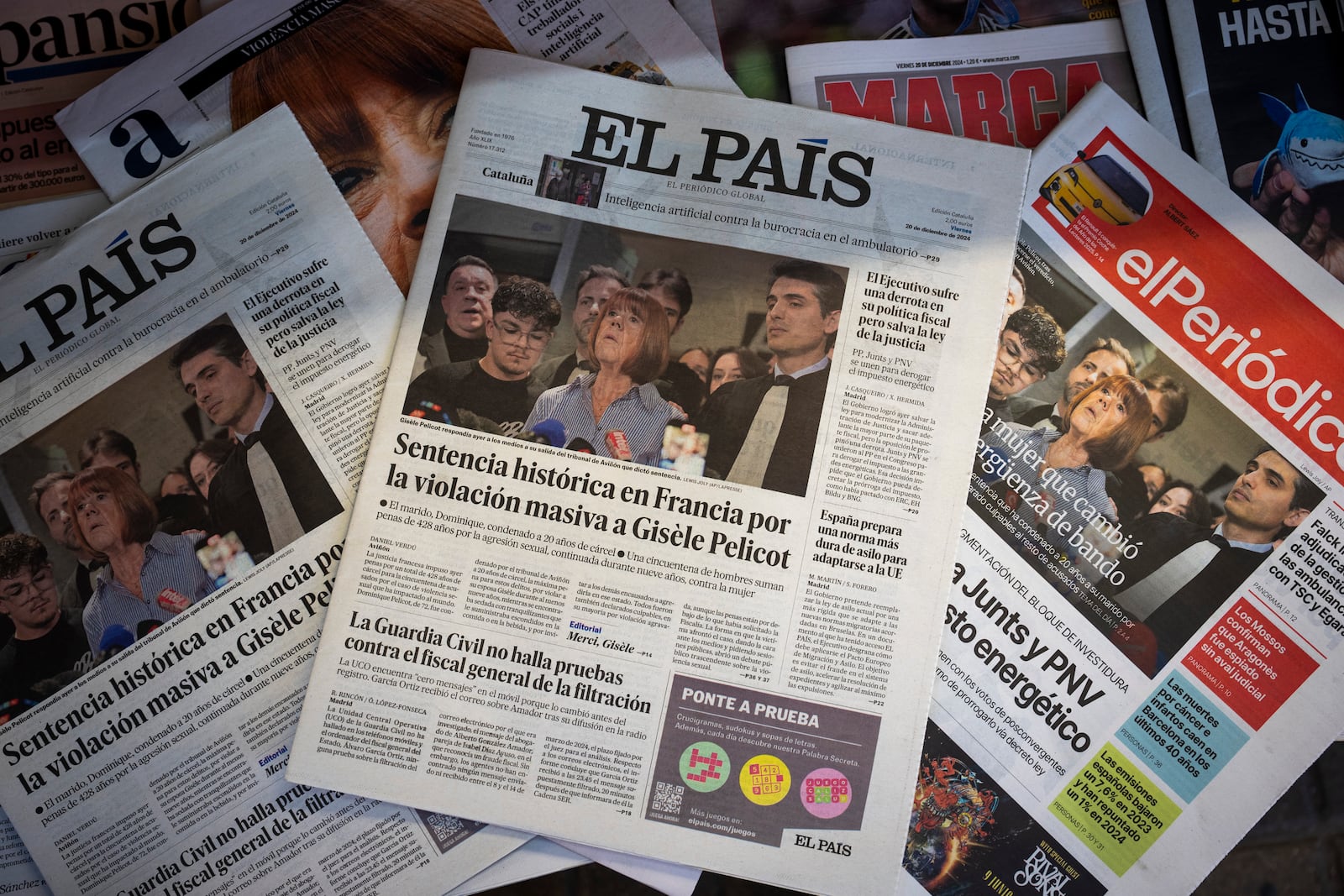 Spanish national newspapers publish the case of Gisele Pelicot on their front pages, photographed at a news stand in Barcelona, Spain, Friday, Dec. 20, 2024. (AP Photo/Emilio Morenatti)