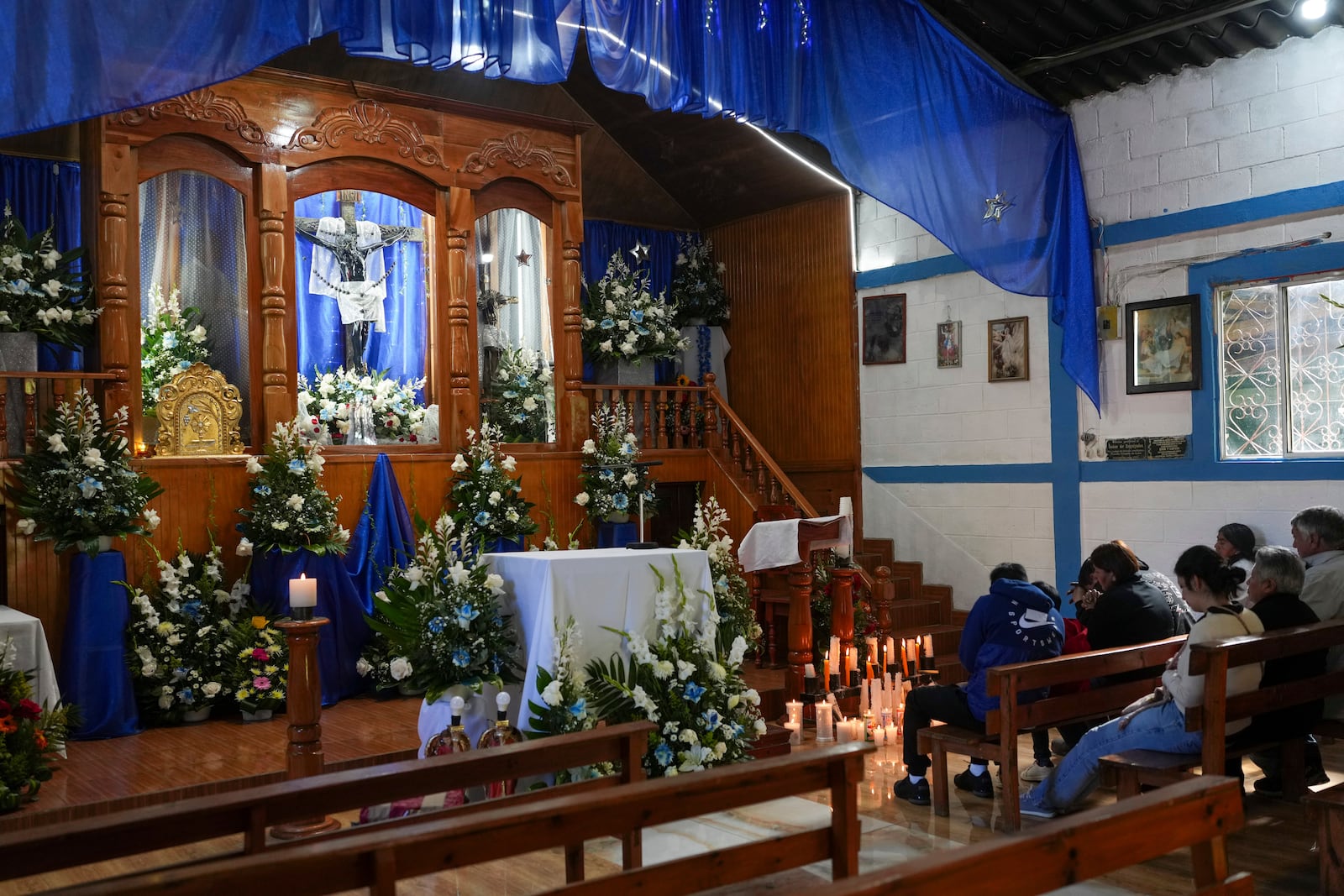 Pilgrims pray before a replica of the statue of the Black Christ of Esquipulas at the church of the Black Christ in Tejutla, in Guatemala's San Marcos department, on his feast day, Wednesday, Jan. 15, 2025. (AP Photo/Moises Castillo)