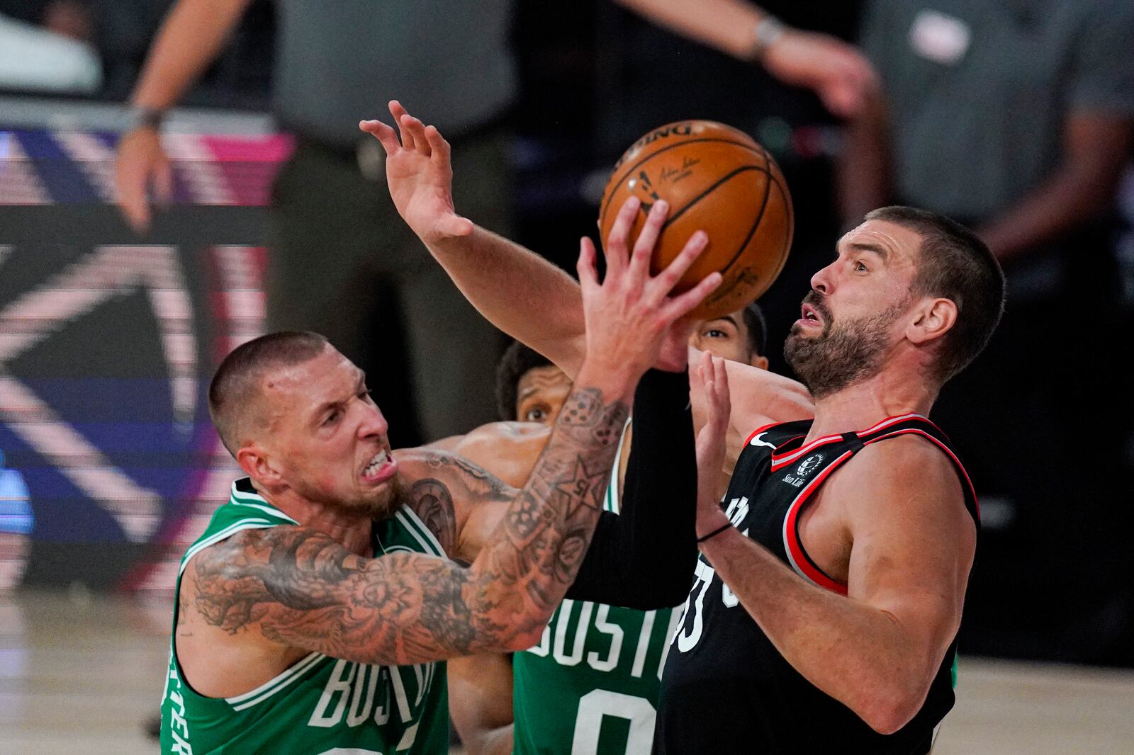 Boston Celtics center Daniel Theis (27) shoots over Toronto Raptors center Marc Gasol (33) during the second half of an NBA conference semifinal playoff basketball game Wednesday, Sept. 9, 2020, in Lake Buena Vista, Fla. (AP Photo/Mark J. Terrill)