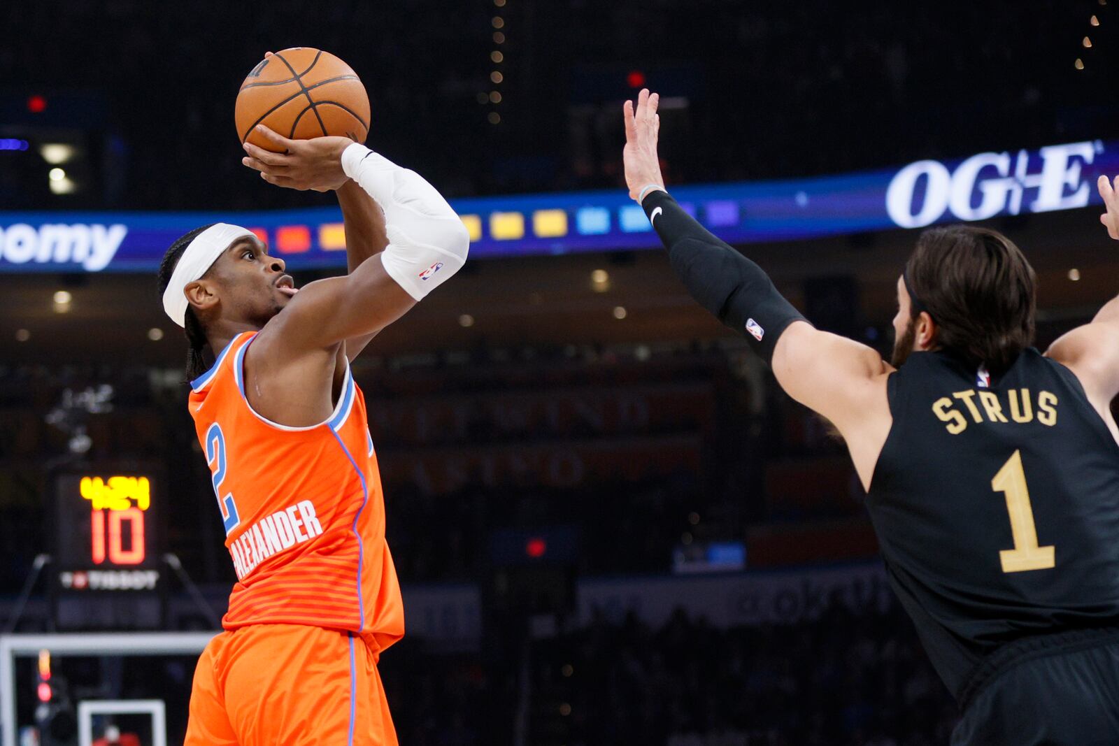 Oklahoma City Thunder guard Shai Gilgeous-Alexander (2) looks to shoot over Cleveland Cavaliers guard Max Strus (1) during the first half of an NBA basketball game Thursday, Jan. 16, 2025, in Oklahoma City. (AP Photo/Nate Billings)