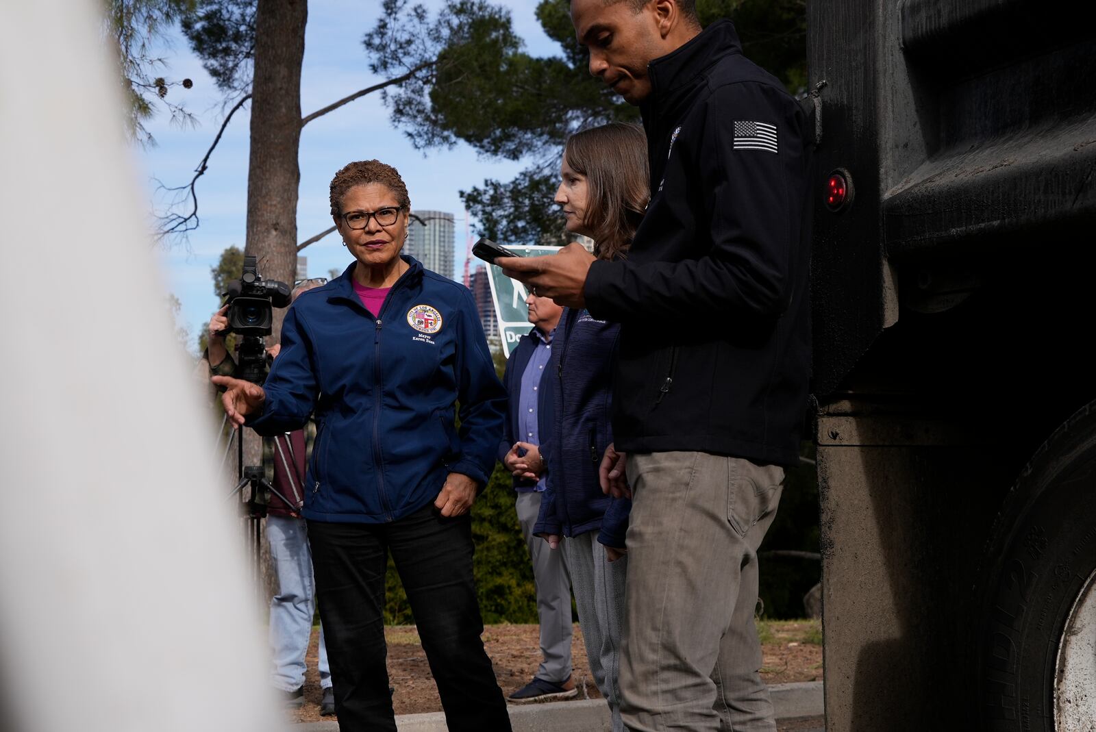 Los Angeles Mayor Karen Bass tours a staging area Wednesday, Jan. 22, 2025 in Los Angeles, where city workers prepare to reinforce burned land ahead of rains expected this weekend. (AP Photo/Brittany Peterson)