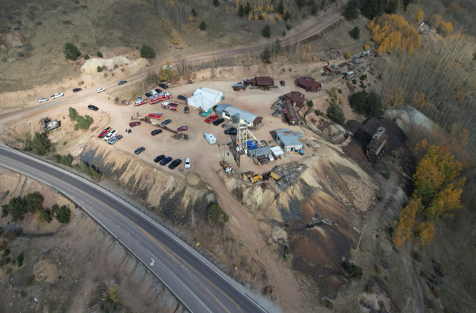 Emergency personnel stage outside the Mollie Kathleen Gold Mine in Cripple Creek, Colo., Thursday, Oct. 10, 2024, after one person died in an equipment malfunction during a tour of the mine according to the Teller County Sheriff's Department. Twelve other people remained trapped 500 feet below as of 4:30 p.m. (Arthur Trickette-Wile/The Gazette via AP)