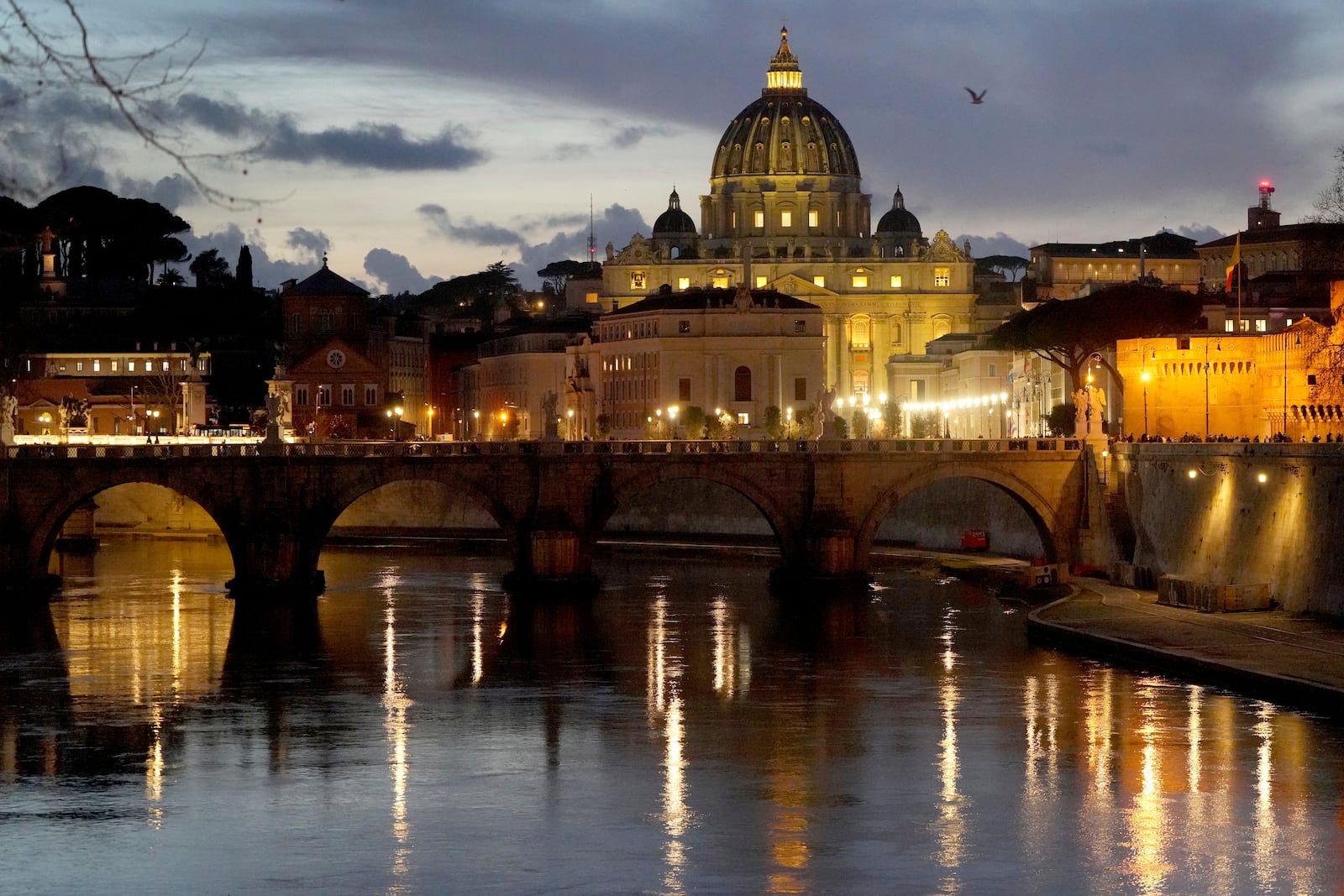 St. Peter's Basilica at The Vatican is seen at dusk across the river Tiber in Rome, Italy Friday, Feb. 28, 2025. (AP Photo/Kirsty Wigglesworth)