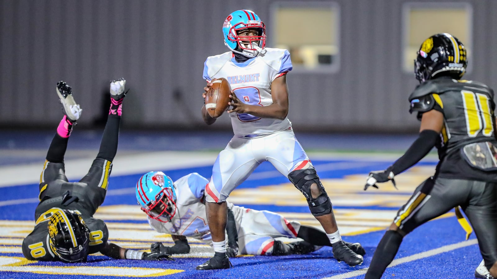 Belmont High School quarterback Aaron Dandrea drops back to pass in the end zone during their game against Meadowdale on Wednesday night at Dayton Welcome Stadium. The Lions won 22-2. Michael Cooper/CONTRIBUTED