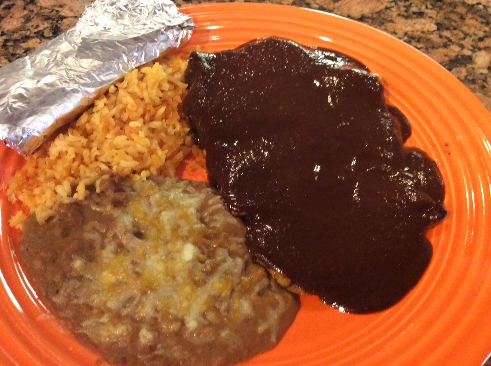 The Mole del Sur, grilled chicken breast topped with mole sauce served with rice, beans the tortilla, at Chiapas Mexican Grill in Centerville. MARK FISHER/STAFF