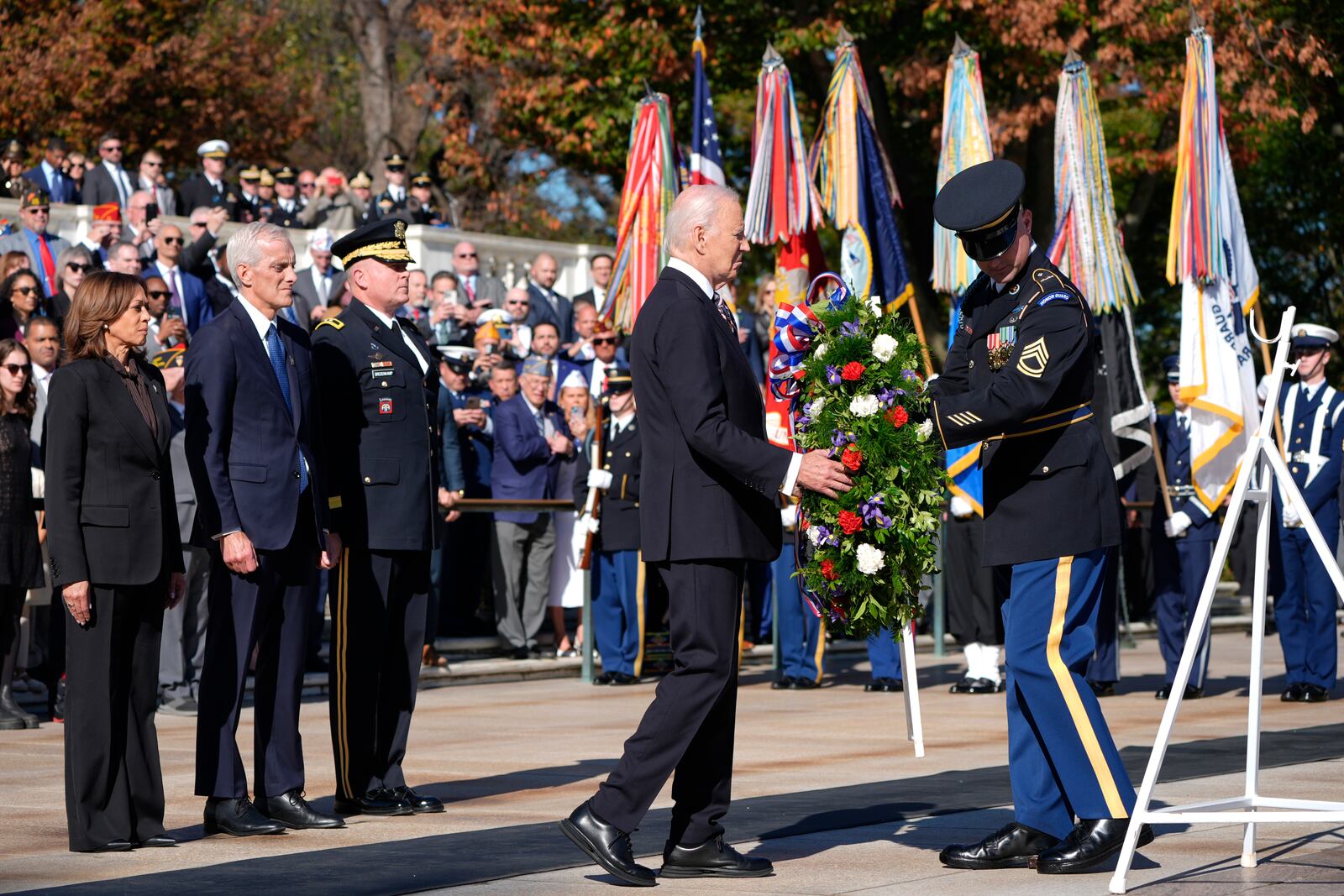 President Joe Biden, second from right, lays a wreath at the Tomb of the Unknown Soldier as Vice President Kamala Harris, from left, Veterans Affairs Secretary Denis McDonough and Maj. Gen. Trevor Bredenkamp, commanding general of the Joint Task Force-National Capital Region and the U.S. Military District of Washington, watch, on National Veterans Day Observance at Arlington National Cemetery in Arlington, Va., Monday, Nov. 11, 2024. (AP Photo/Mark Schiefelbein)