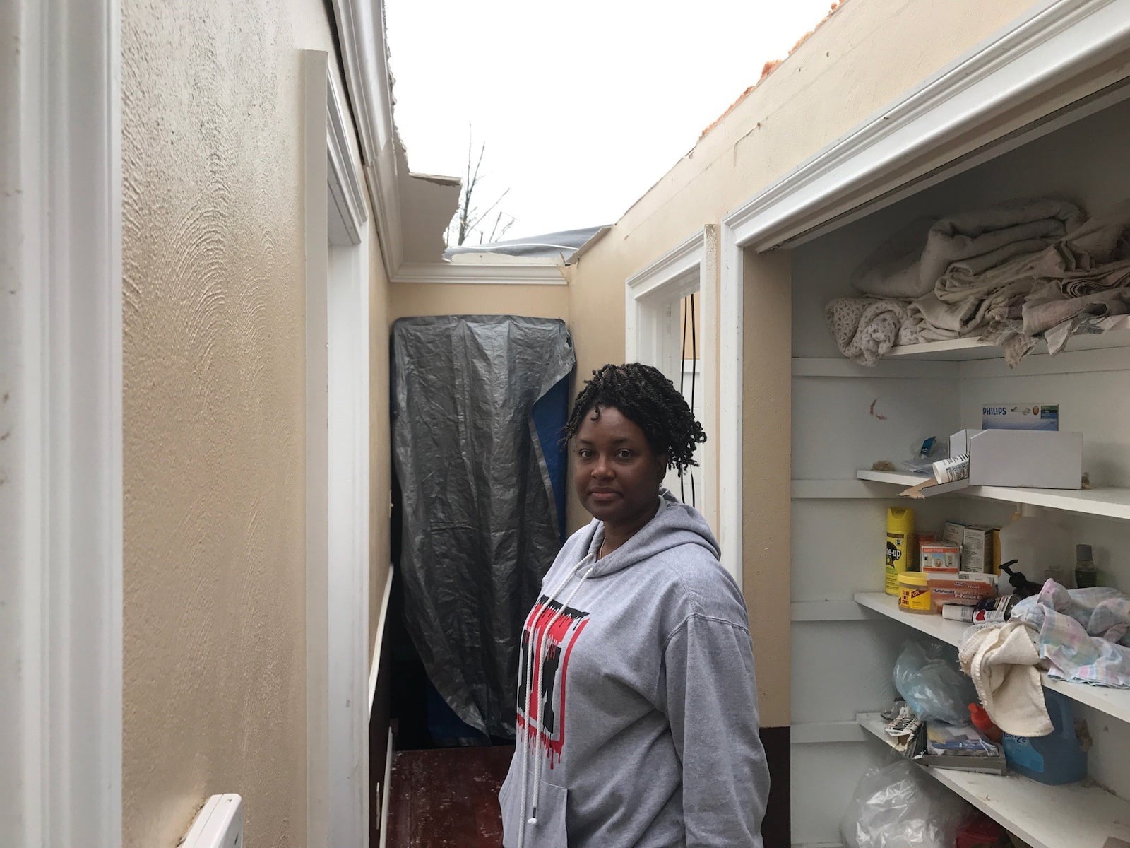 Tosha Johnson in roofless upstairs hall of home on Filburn Lane off Denlinger Road in the Shiloh Gardens section of Trotwood. Photo by Tom Archdeacon