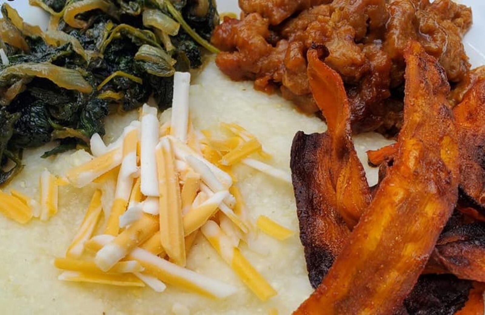 A new vegan restaurant called Cafe 1610 is scheduled to open Labor Day weekend on Wayne Avenue in Dayton. One of its menu items is the Grits Bowl, consisting of bbq soy curls, braised mixed baby greens and carrot bacon atop creamy grits. CONTRIBUTED