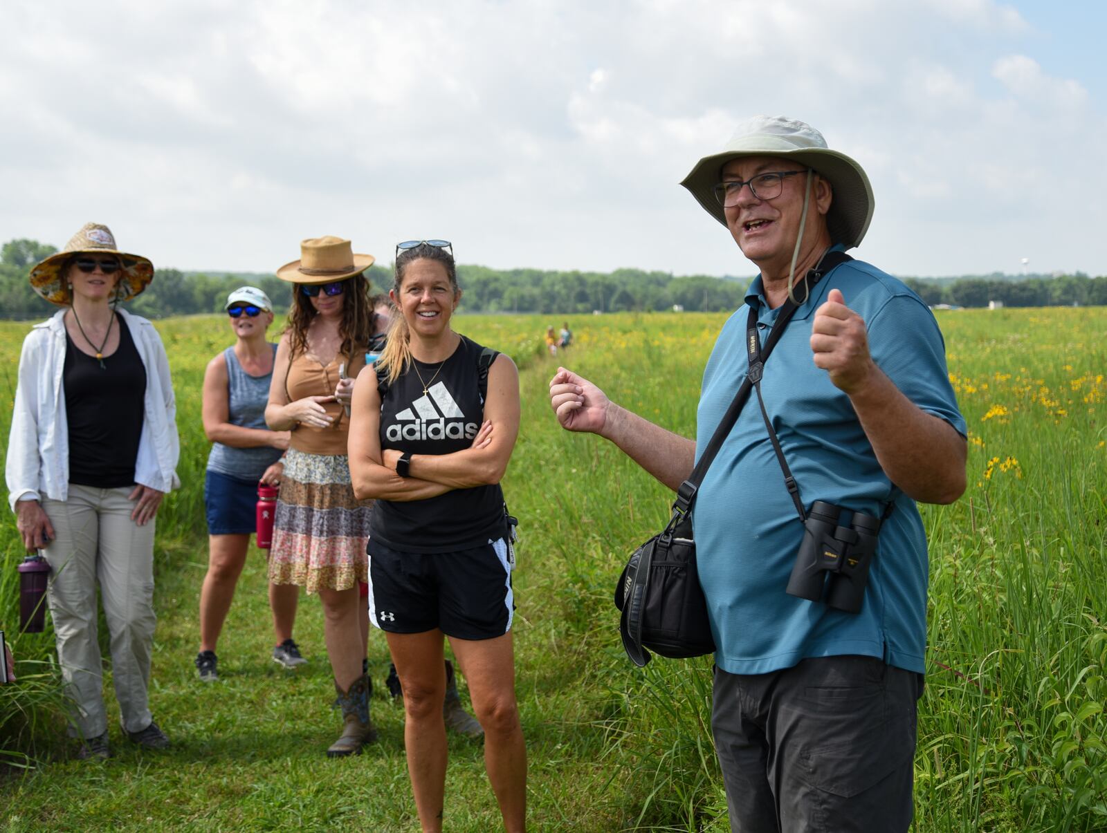 Dave Nolin, retired director of Five Rivers MetroParks, gives more than a dozen visitors an informative walking tour about the more than 300 species of wildflowers in Huffman Prairie, Wright-Patterson Air Force Base, Ohio, on July 20, 2022. Huffman Prairie is the largest natural tall-grass prairie in Ohio. U.S. Air Force photo/Matthew Clouse