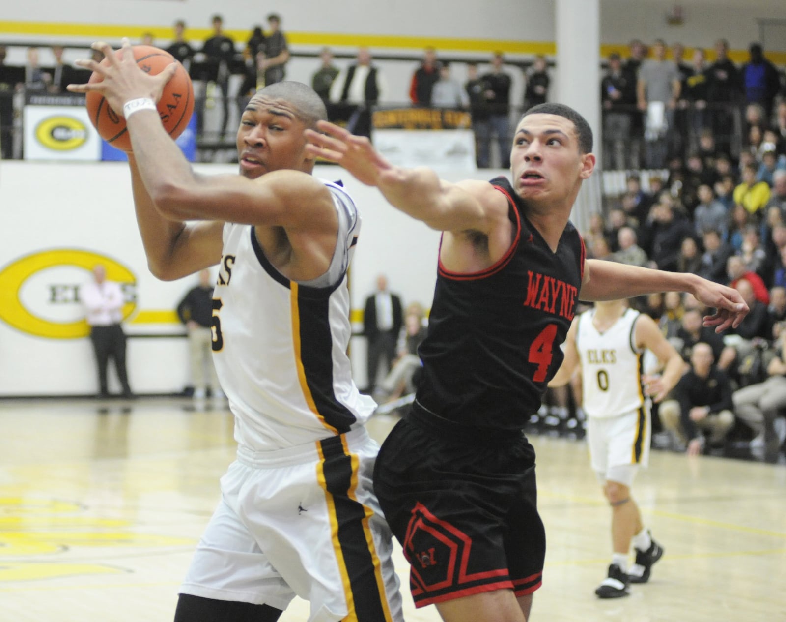 Wayne, including Brian Hill (right), had no answer for Centerville 6-9 center Mo Njie (with ball), who scored 16 points. Centerville defeated visiting Wayne 69-44 in a boys high school basketball game on Friday, Feb. 15, 2019. MARC PENDLETON / STAFF