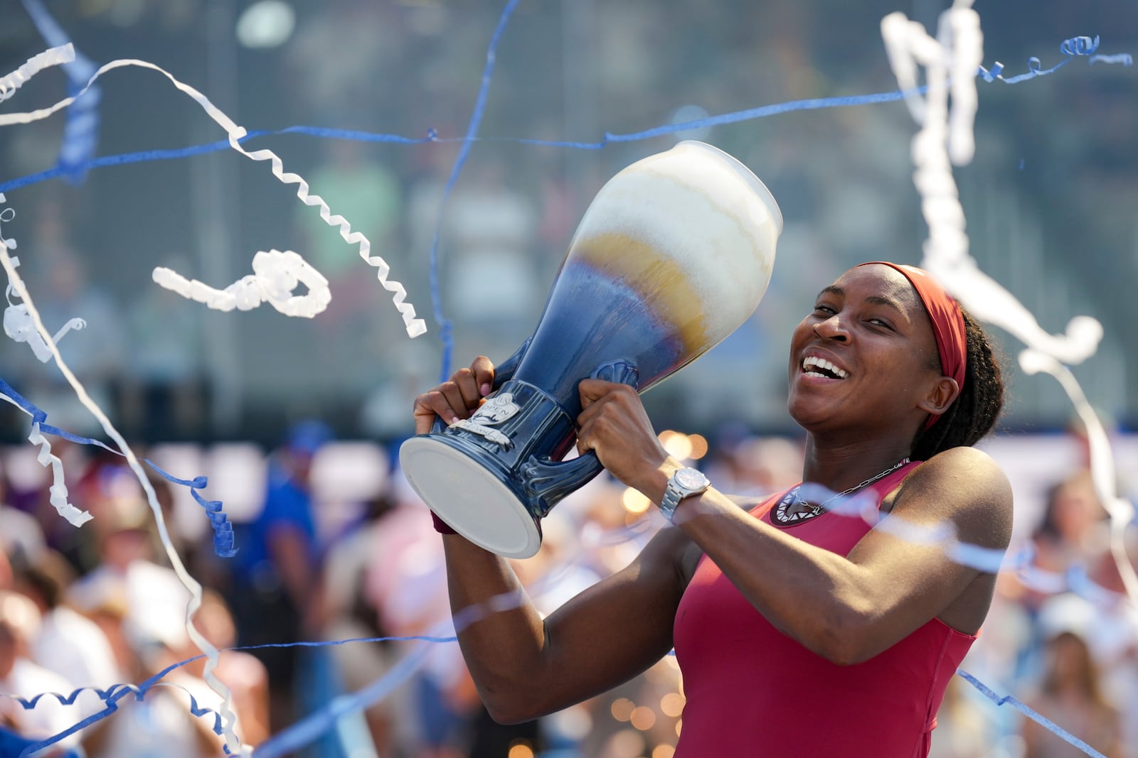 Coco Gauff, of the United States, celebrates with the Rookwood Cup as she poses for photos after defeating Karolina Muchova, of the Czech Republic, during the women's singles final of the Western & Southern Open tennis tournament, Sunday, Aug. 20, 2023, in Mason, Ohio. (AP Photo/Aaron Doster)