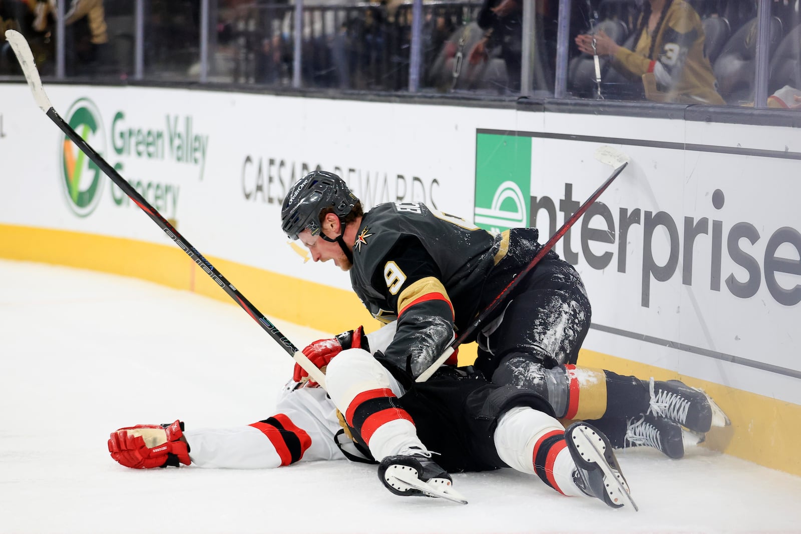 Vegas Golden Knights center Jack Eichel (9) checks on New Jersey Devils center Jack Hughes (86) after a collision during the third period of an NHL hockey game Sunday, March 2, 2025, in Las Vegas. (AP Photo/Ian Maule)