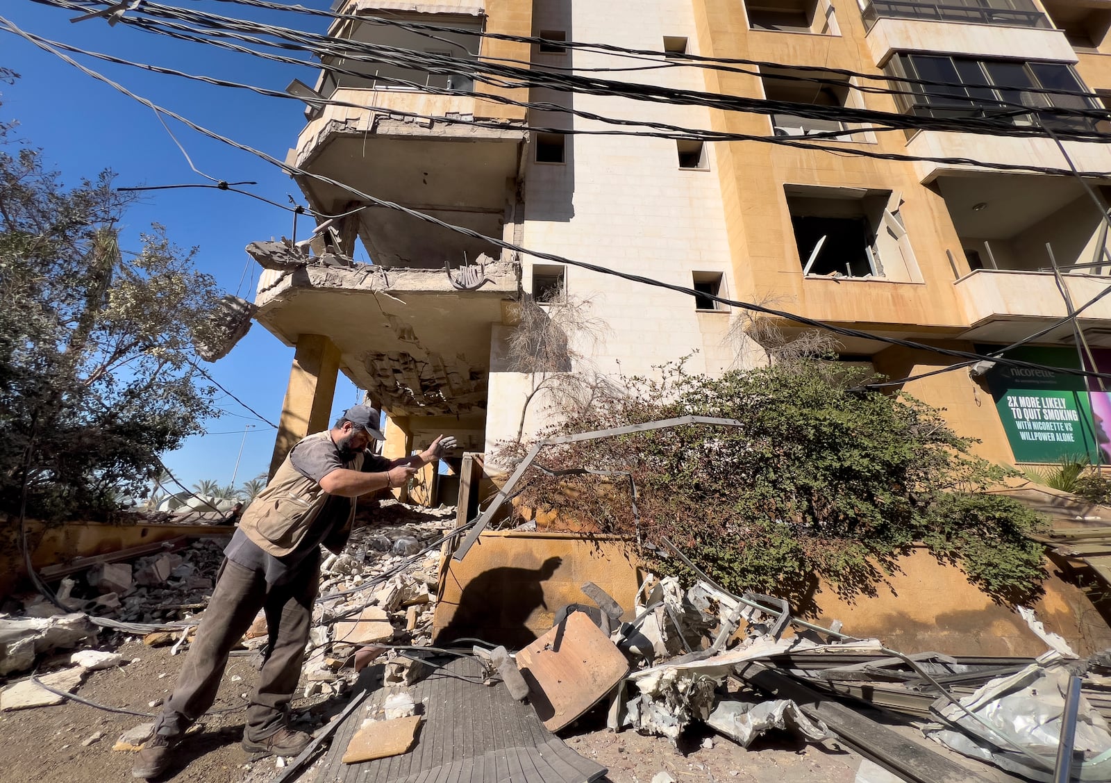 A worker removes the debris of a building that housed the office of pan-Arab TV channel Al-Mayadeen, which is politically allied with Hezbollah, that was hit Wednesday night by an Israeli airstrike, in southern Beirut, Lebanon, Thursday, Oct. 24, 2024. (AP Photo/Hussein Malla)