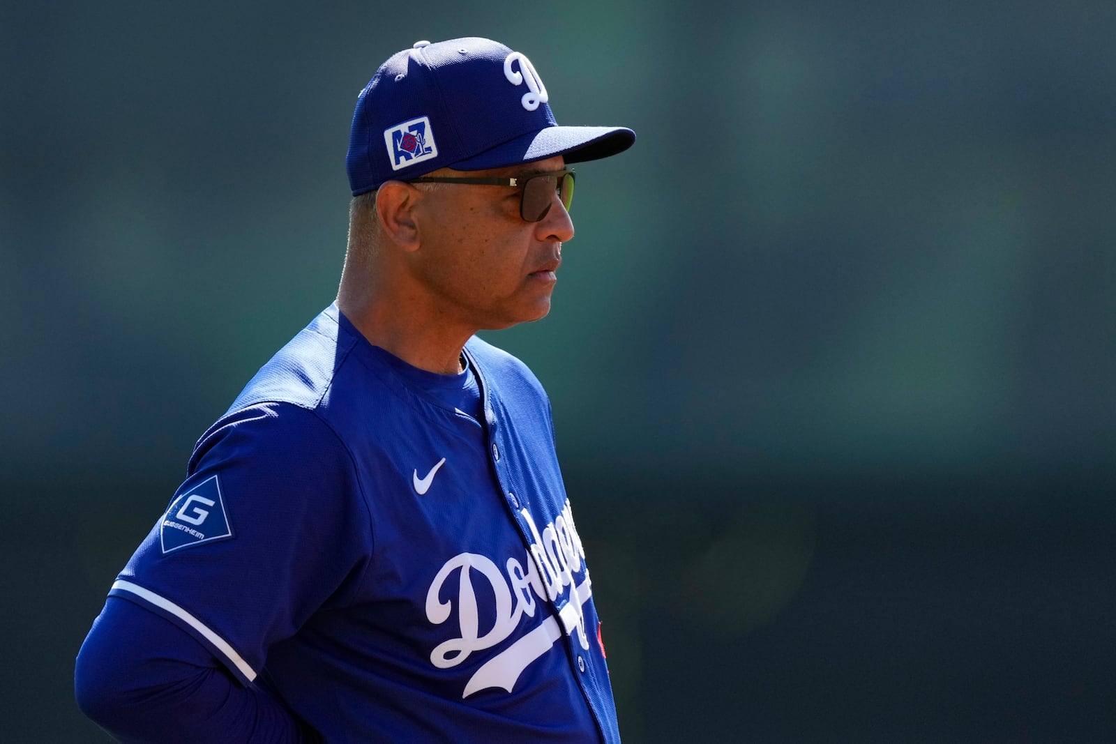 Los Angeles Dodgers manager Dave Roberts watches during spring training baseball practice, Tuesday, Feb. 18, 2025, in Phoenix. (AP Photo/Ashley Landis)