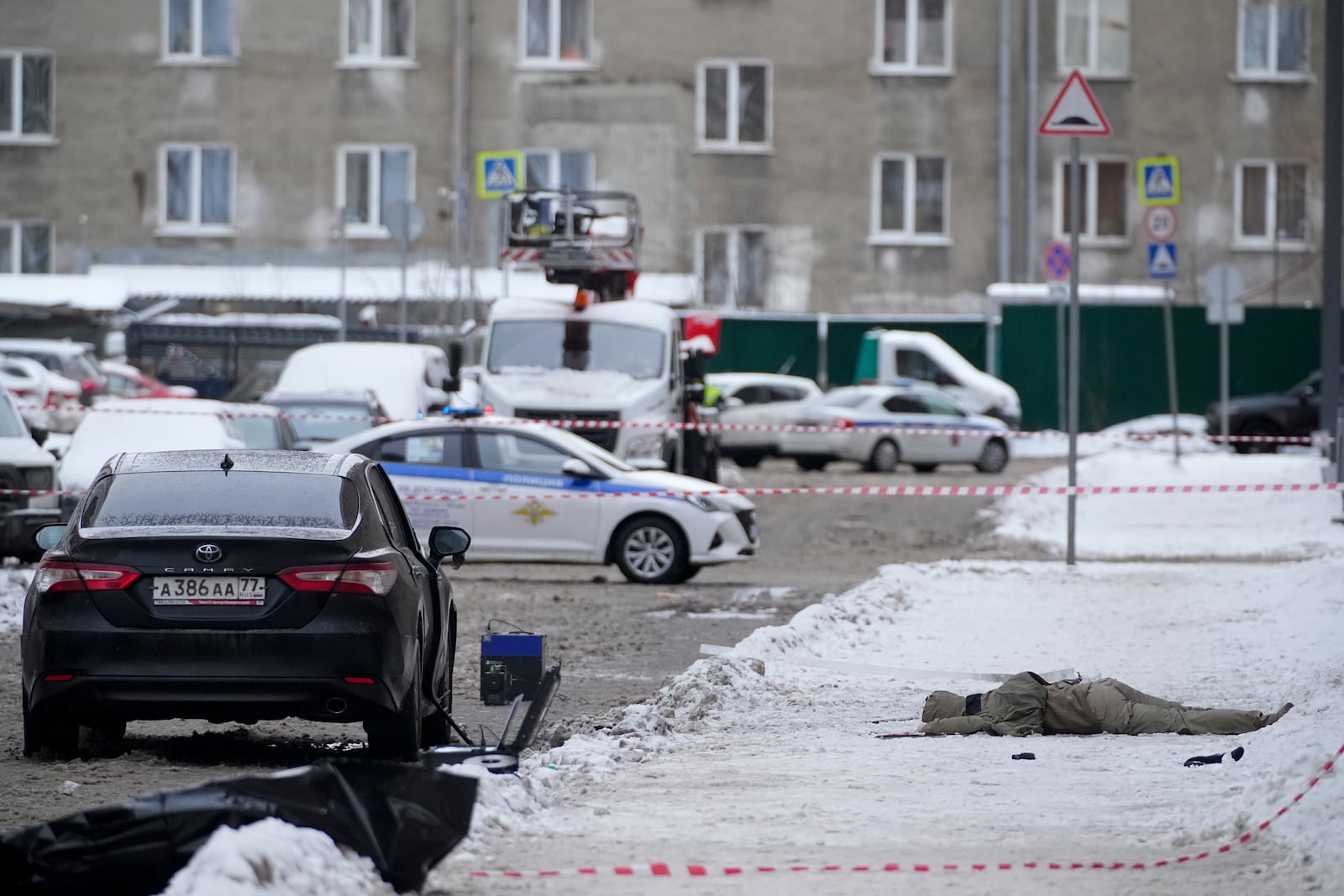 A body lies at the place where Lt. General Igor Kirillov, the head of Russia's Nuclear, Biological, and Chemical Defence Forces was killed by an explosive device planted close to a residential apartment's block in Moscow, Russia, Tuesday, Dec. 17, 2024. (AP Photo)