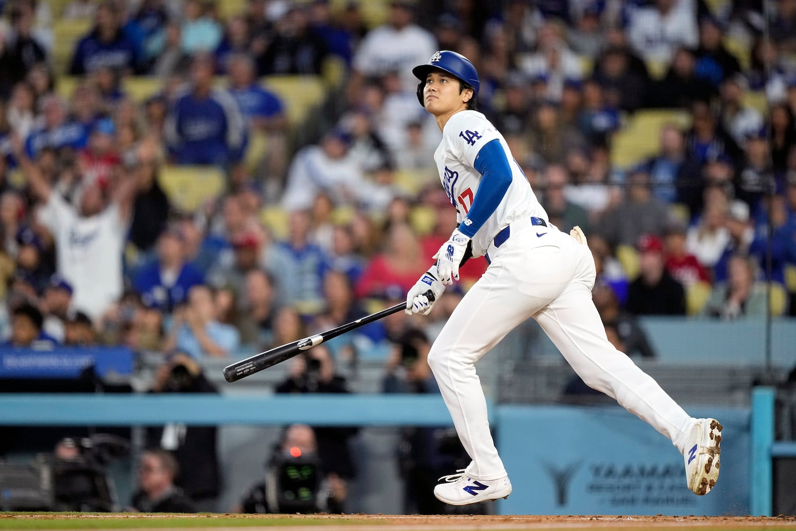 FILE - Los Angeles Dodgers designated hitter Shohei Ohtani heads to first after hitting a two-run home run during the third inning of a baseball game against the Cincinnati Reds Friday, May 17, 2024, in Los Angeles. (AP Photo/Mark J. Terrill, File)