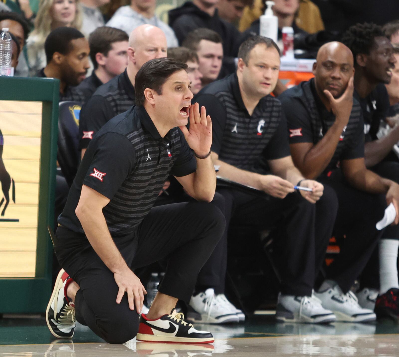 Cincinnati head coach Wes Miller calls in an offensive play against Baylor in the first half of an NCAA college basketball game, Tuesday, Jan. 7, 2025, in Waco, Texas. (Rod Aydelotte/Waco Tribune-Herald via AP)