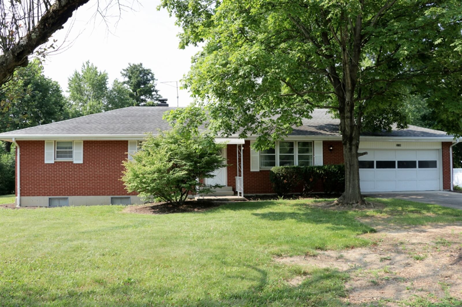 Sliding patio doors off the family room open out to a covered concrete patio. The house sits on nearly a half-acre property. The brick ranch has three bedrooms and two full bathrooms and a full, semi-finished basement. Kathy Tyler/CONTRIBUTED