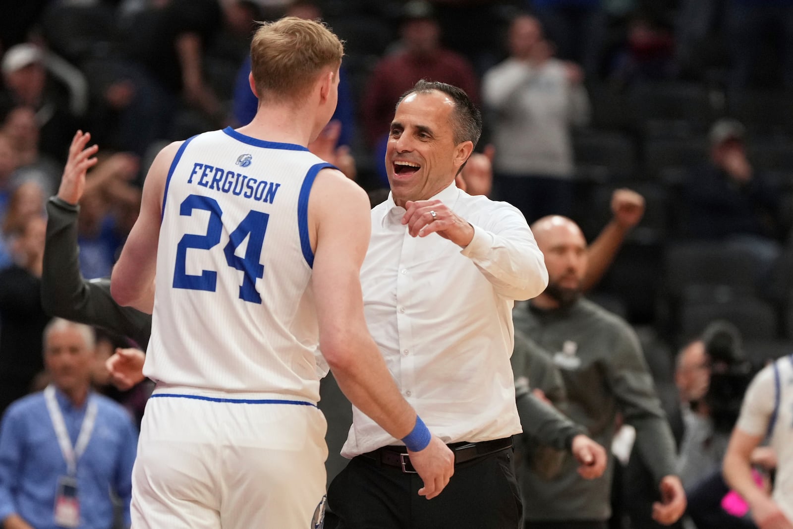 Drake head coach Ben McCollum hugs Nate Ferguson (24) in the final seconds against Bradley in the championship game of the Missouri Valley Conference NCAA college basketball tournament Sunday, March 9, 2025, in St. Louis. (AP Photo/Jeff Roberson)