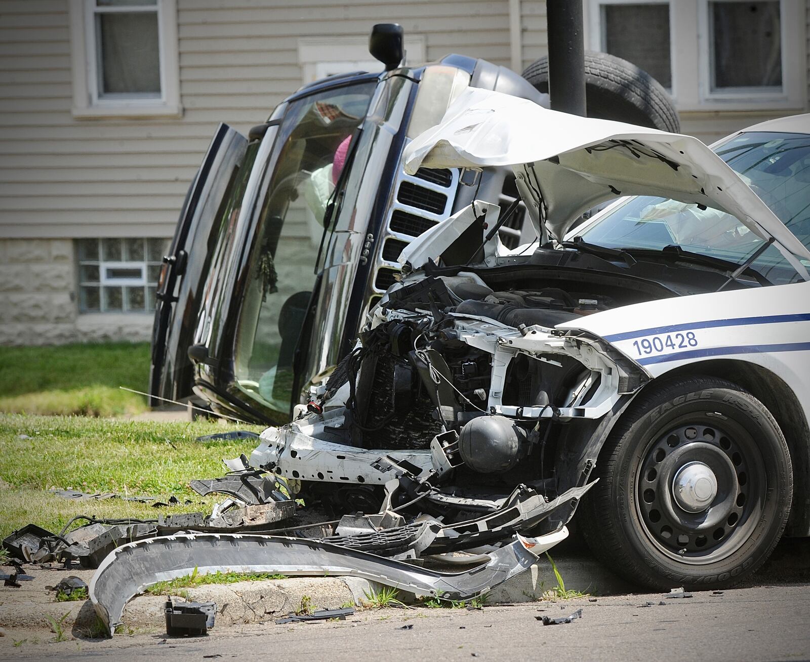 A Dayton police cruiser sustained heavy front-end damage during a crash Thursday, May 23, 2024, at West Third Street and North Decker Avenue. A second vehicle landed on its side. MARSHALL GORBY/STAFF