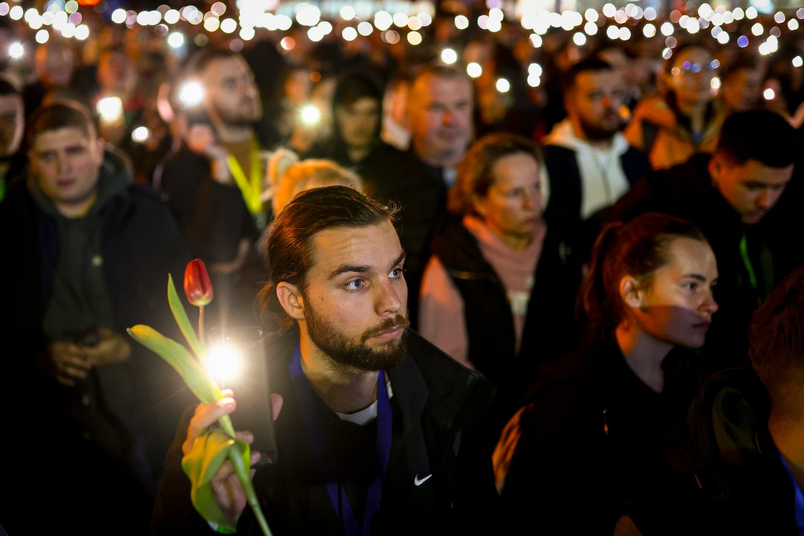 People hold up their mobile phone lights during a protest over the collapse of a concrete canopy that killed 15 people more than two months ago, in Novi Sad, Serbia, Friday, Jan. 31, 2025. (AP Photo/Armin Durgut)