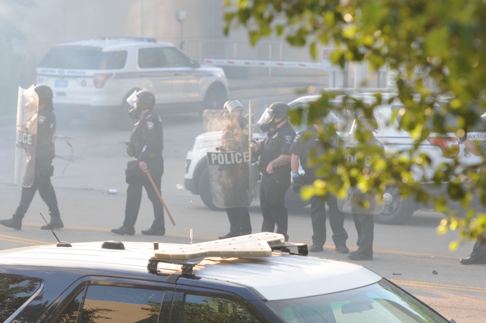 Protesters threw water bottles and rocks, and spray painted profanity, and police retaliated with tear gas. Some protesters picked up the canisters and threw tear gas back at police. Most protesters ran from the chemicals used on the crowd.