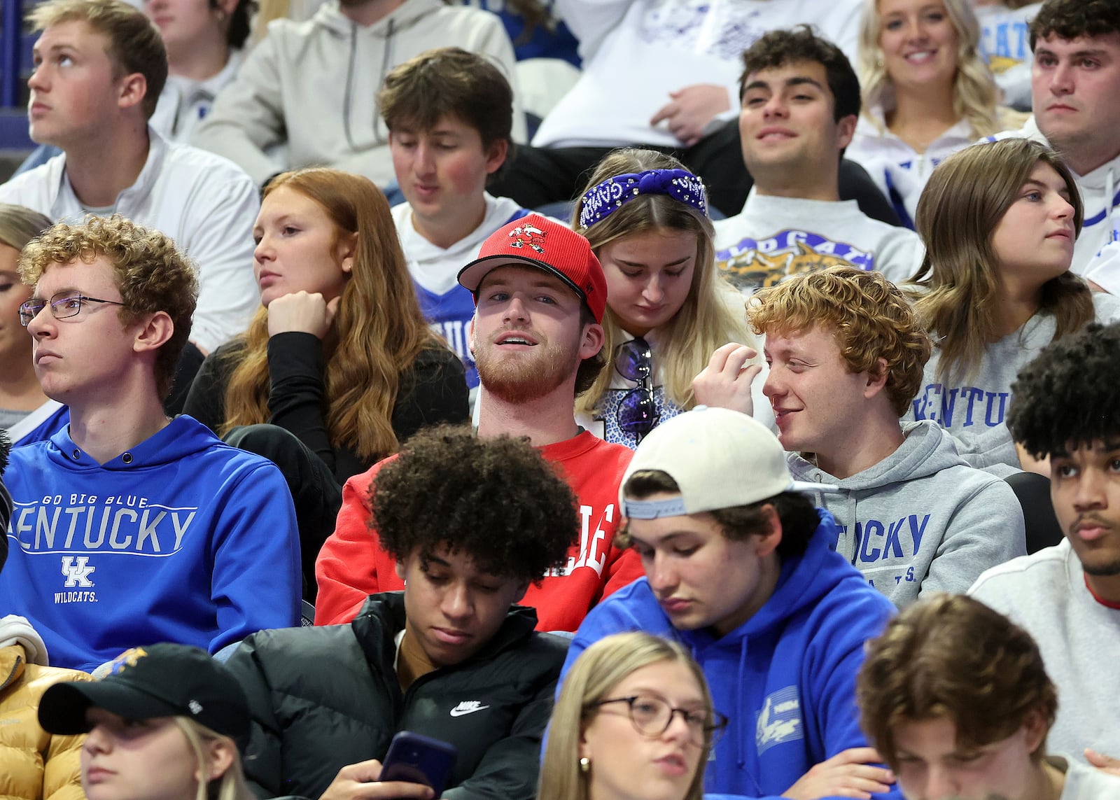 A lone Louisville fan, center, sits in the Kentucky student section before an NCAA college basketball game between the teams in Lexington, Ky., Saturday, Dec. 14, 2024. (AP Photo/James Crisp)