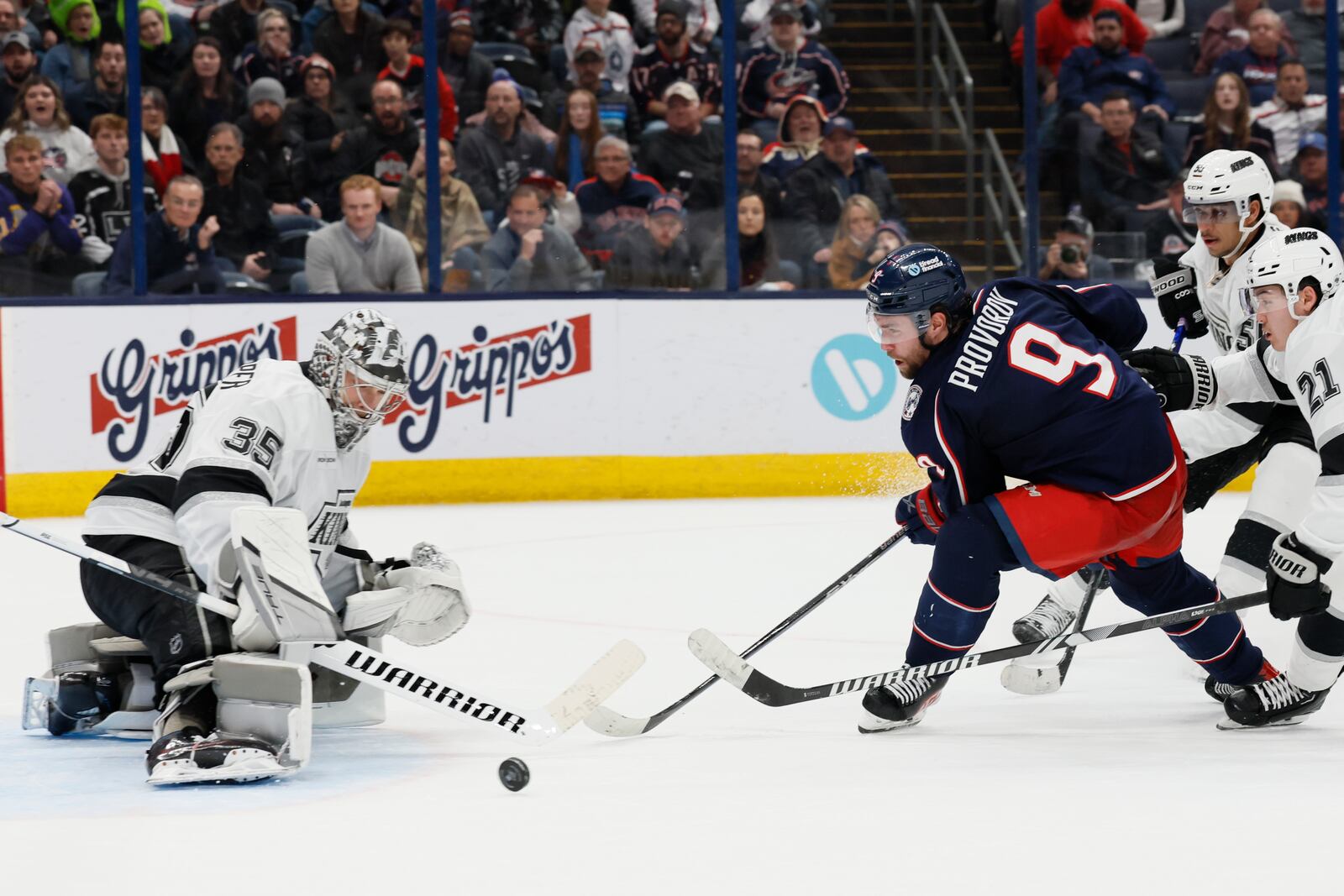 Columbus Blue Jackets' Ivan Provorov (9) shoots against Los Angeles Kings' Darcy Kuemper, left, during the overtime period of an NHL hockey game Saturday, Jan. 25, 2025, in Columbus, Ohio. (AP Photo/Jay LaPrete)