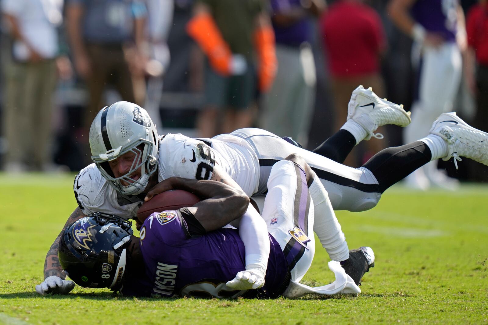 Las Vegas Raiders defensive end Maxx Crosby (98) sacks Baltimore Ravens quarterback Lamar Jackson (8) during the second half of an NFL football game, Sunday, Sept. 15, 2024, in Baltimore. (AP Photo/Stephanie Scarbrough)