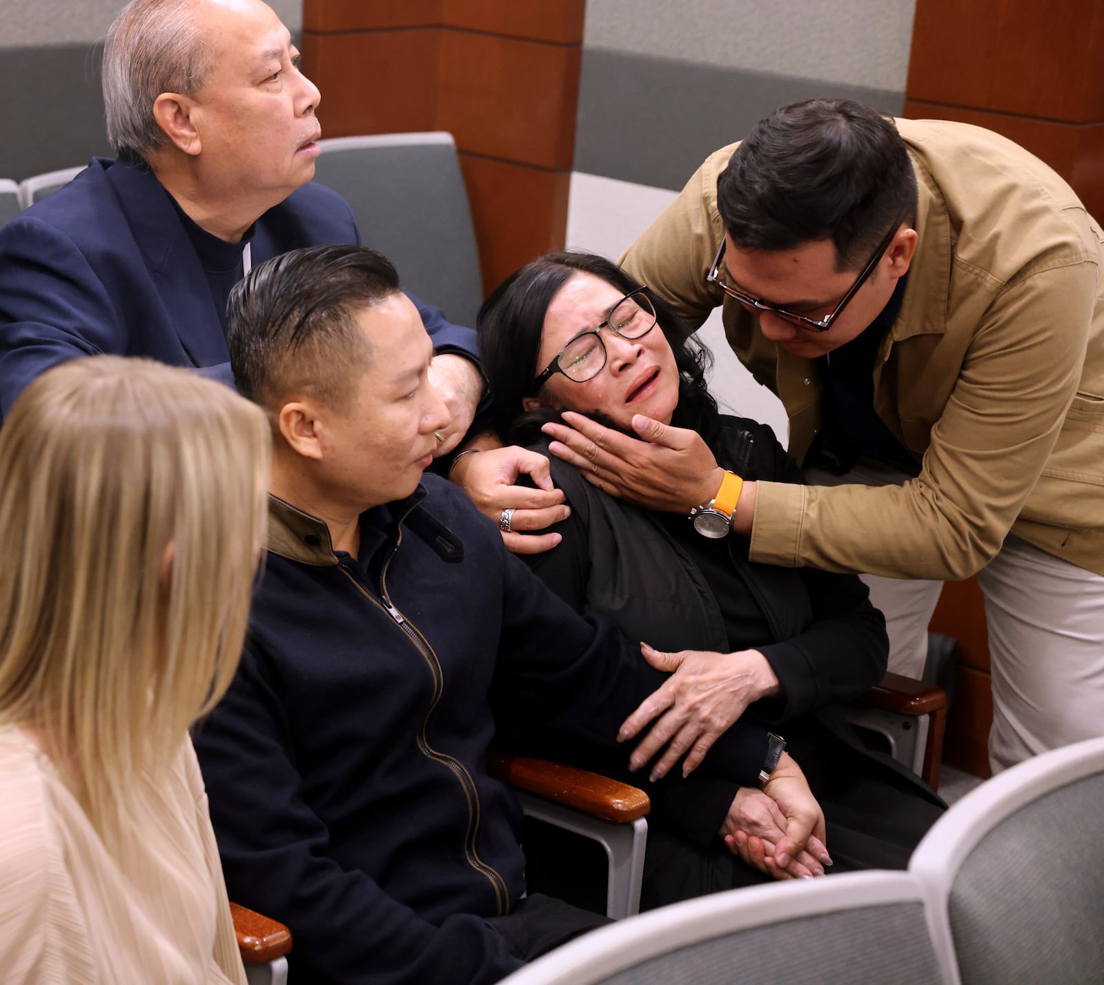 FILE - Bong Le, mother of a stabbing victim Khuong Nguyen, reacts to the guilty verdict in defendant Julius Trotter's murder trial, Tuesday, Oct. 29, 2024, at the Regional Justice Center in Las Vegas. Comforting Le is Hung Quang Nguyen, husband of a stabbing victim Sang Nghia, second left, and Tuan Trinh. At rear is interpreter Jimmy Tong Nguyen. Trotter was sentenced Thursday, Oct. 31, to serve life in state prison with no chance of parole. (K.M. Cannon/Las Vegas Review-Journal via AP)