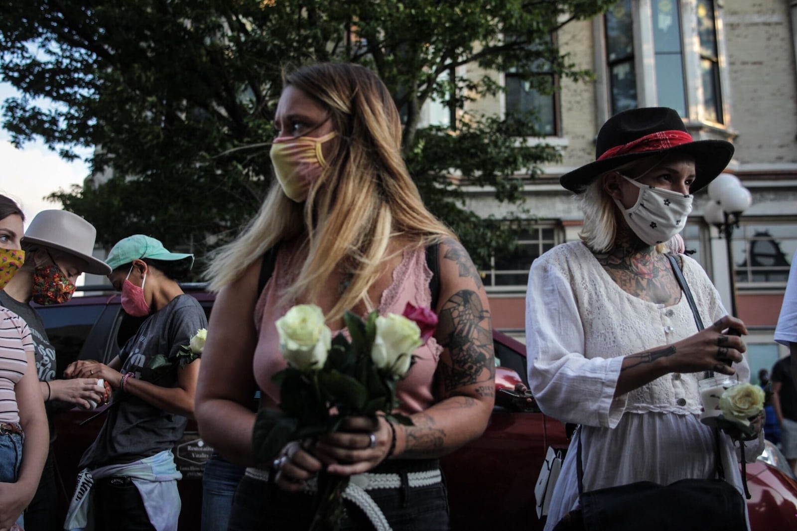 Holland Ramsey, left and Hailey Omar both from Dayton, are a part of a small crowd of people who participated in a memorial on Fifth St. in the Oregon District on Tuesday Aug. 4, 2020. It marked the one-year anniversary of the mass shooting that killed nine people and wounded dozens of others.