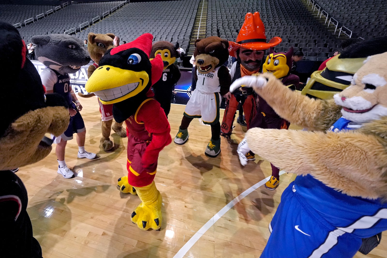 Mascots from Big 12 schools dance during the NCAA college Big 12 women's basketball media day, Tuesday, Oct. 22, 2024, in Kansas City, Mo. (AP Photo/Charlie Riedel)