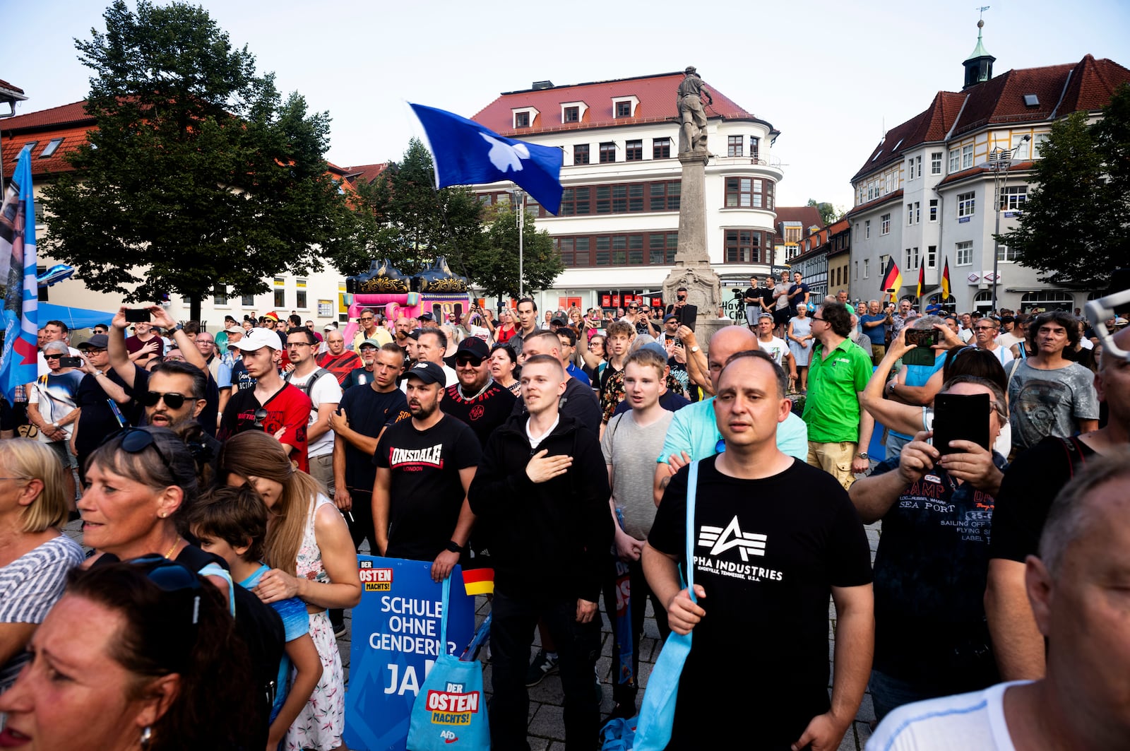 FILE - Supporters of the far-right Alternative for Germany party, AfD, sing the national anthem as they attend an election campaign rally of the party for the upcoming state elections in Suhl, Germany, Aug. 13, 2024. (AP Photo/Markus Schreiber, File)