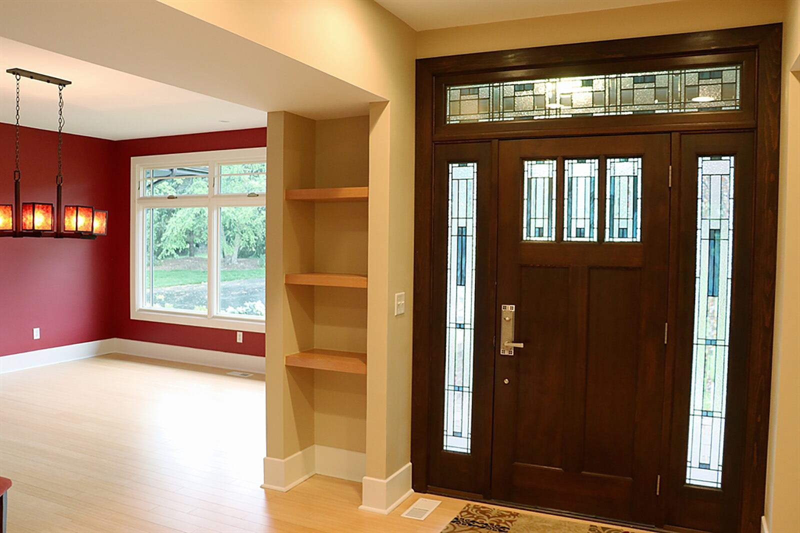 Formal entry opens through a leaded-glass door with matching sidelines into a foyer that spreads into the formal areas and flows into the more casual spaces. Built-in displays accent the transition walkway from foyer into the formal dining room. CONTRIBUTED PHOTO BY KATHY TYLER