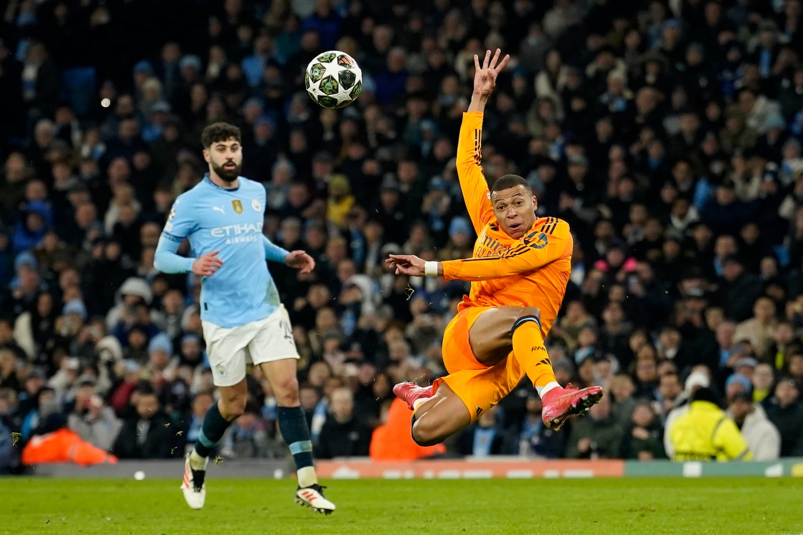 Real Madrid's Kylian Mbappe scores his sides first goal during the Champions League playoff first leg soccer match between Manchester City and Real Madrid at the Etihad Stadium in Manchester, England, Tuesday, Feb. 11, 2025. (AP Photo/Dave Thompson)