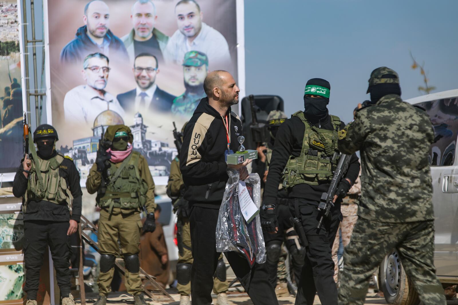 Hostage Iair Horn, 46, who is a dual citizen of Israel and Argentina is escorted by Hamas fighters as he is handed over to the Red Cross in Khan Younis, Gaza Strip, Saturday, Feb. 15, 2025. (AP Photo/Jehad Alshrafi)