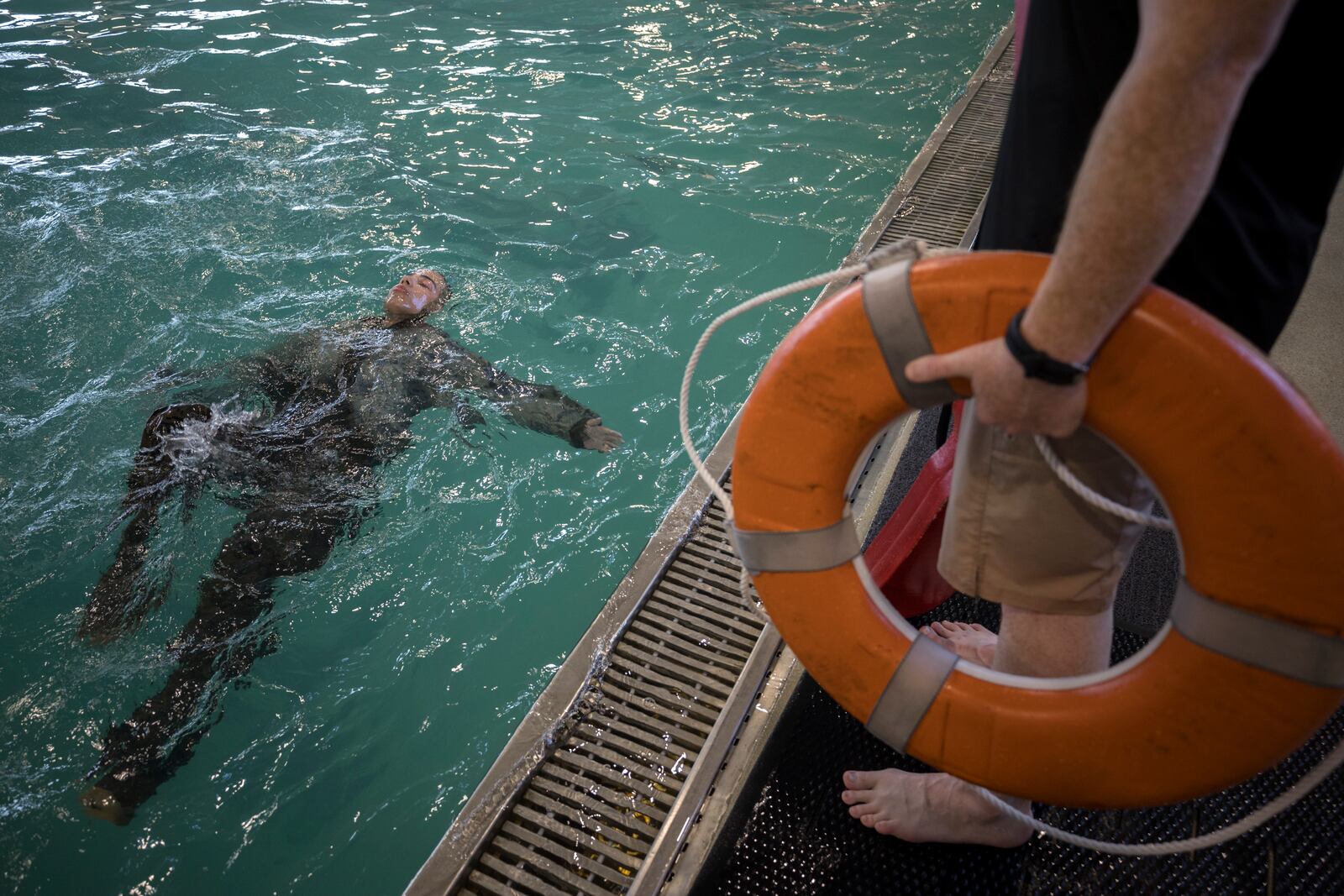 A male U.S. Marine Corps swim instructor, right, watches over a recruit during swim training at the Marine Corps Recruit Depot pool, Wednesday, June 28, 2023, in Parris Island, S.C. (AP Photo/Stephen B. Morton)