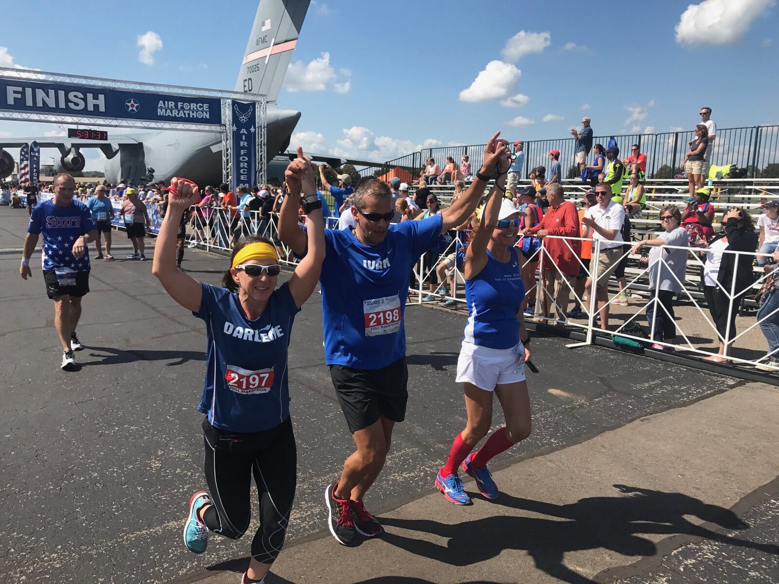 Maj. Ivan Castro (retired) finishes the 2017 Air Force Marathon. To his side are Darlene Matos on his left and Jackie Ferguson on his right while Tom Yoe follows behind. Castro, who was blinded while serving in Iraq in 2006, is the only blind Special Forces officer in U.S. Army history. Tom Archdeacon/contributed