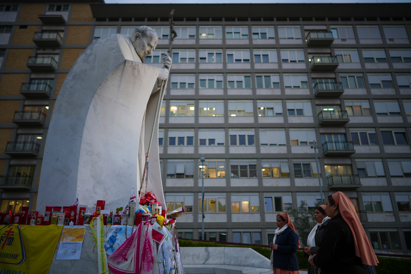 Nuns pray for Pope Francis in front of the Agostino Gemelli Polyclinic, in Rome, Saturday, March 8, 2025, where the Pontiff is hospitalized since Friday, Feb. 14. (AP Photo/Andrew Medichini)