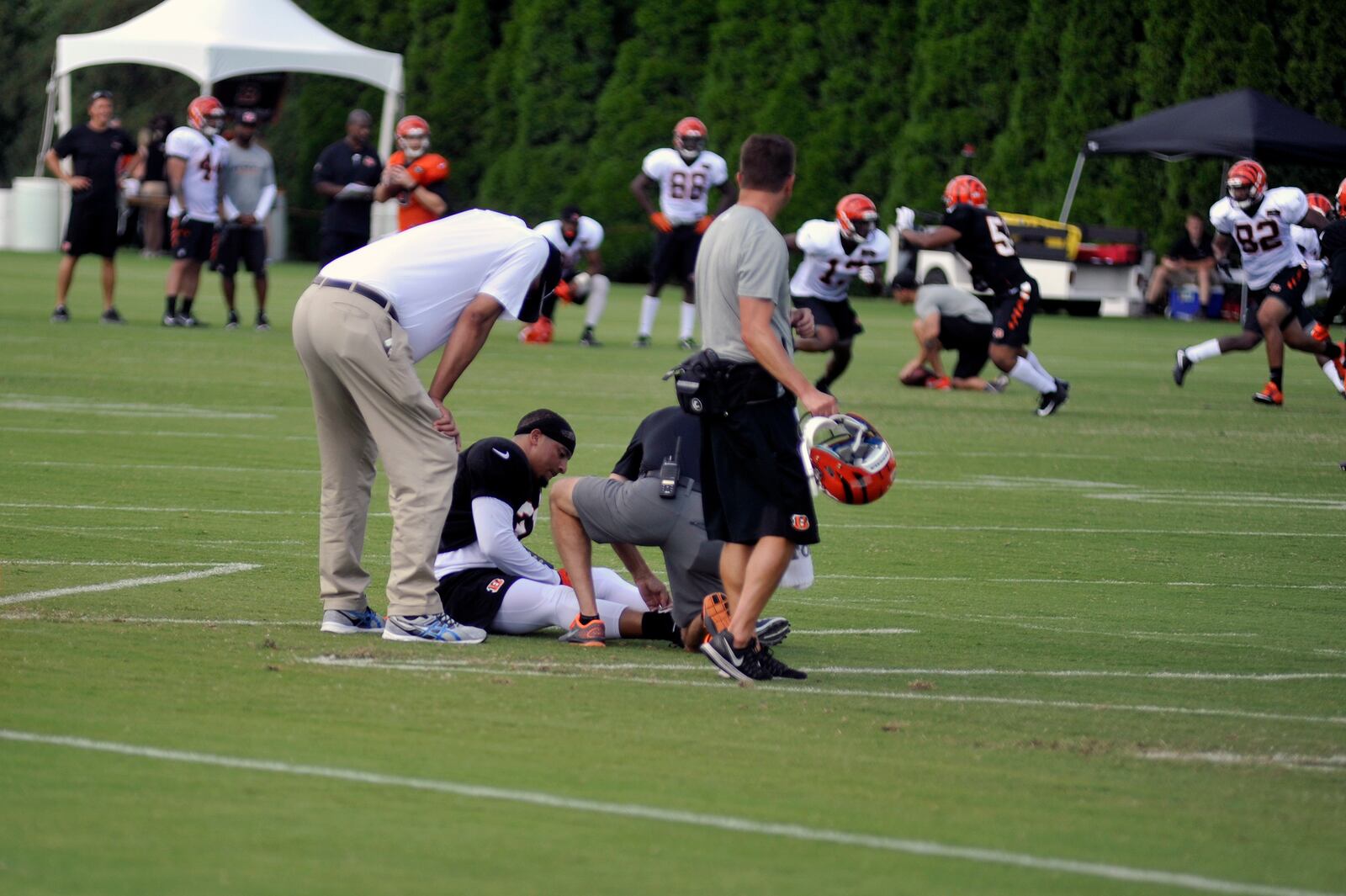 Trainers tend to Derron Smith after the Bengals safety got hurt in Sunday’s practice. JAY MORRISON/STAFF