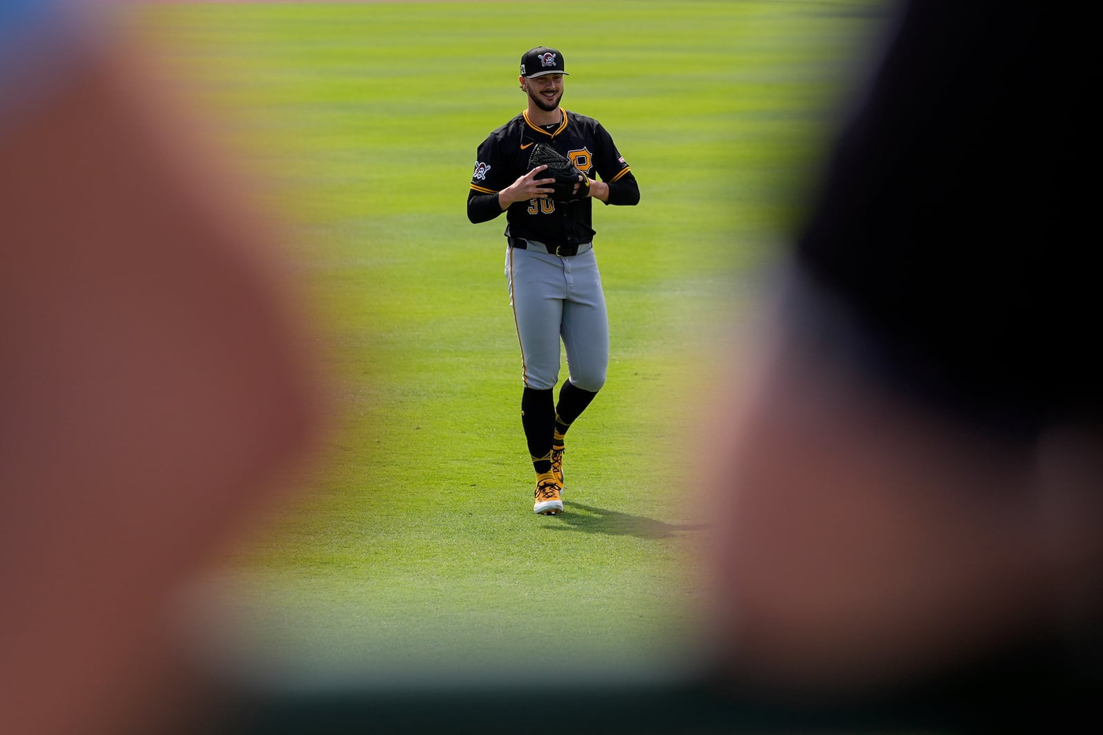 Pittsburgh Pirates starting pitcher Paul Skenes (30) is seen warming up between fans gathered to watch before a spring training baseball game against the Baltimore Orioles, Saturday, March 1, 2025, in Sarasota, Fla. (AP Photo/Stephanie Scarbrough)