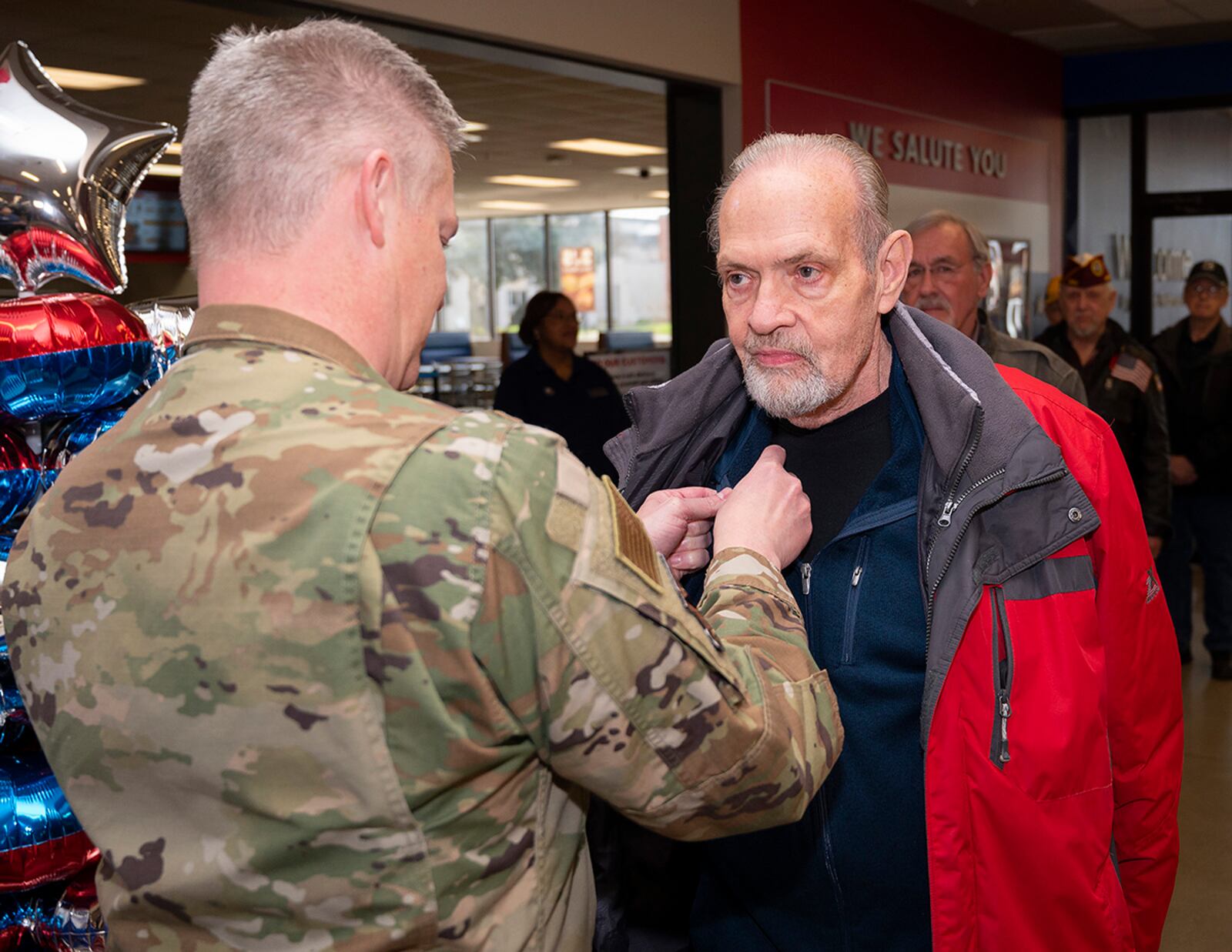 Col. Charles Barkhurst, 88th Air Base Wing vice commander, pins the lapel of Kendall Rogers, Air Force retiree and Vietnam War veteran, during a ceremony March 29 at Wright-Patterson Air Force Base’s Main Exchange in observance of National Vietnam War Veterans Day. The Vietnam War Veterans Recognition Act of 2017 designated March 29 as Vietnam War Veterans Day, marking the day the last American combat troops departed Vietnam and last acknowledged prisoners of war were released in Hanoi. U.S. AIR FORCE PHOTO/R.J. ORIEZ