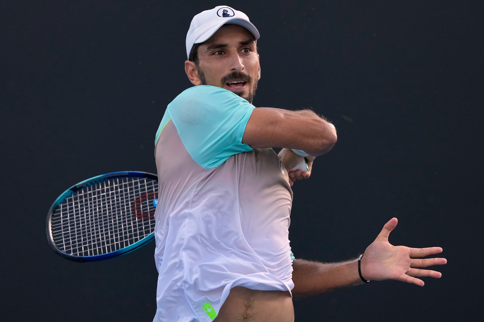 Hady Habib of Lebanon plays a forehand return to Bu Yunchaokete of China during their first round match at the Australian Open tennis championship in Melbourne, Australia, Sunday, Jan. 12, 2025. (AP Photo/Asanka Brendon Ratnayake)