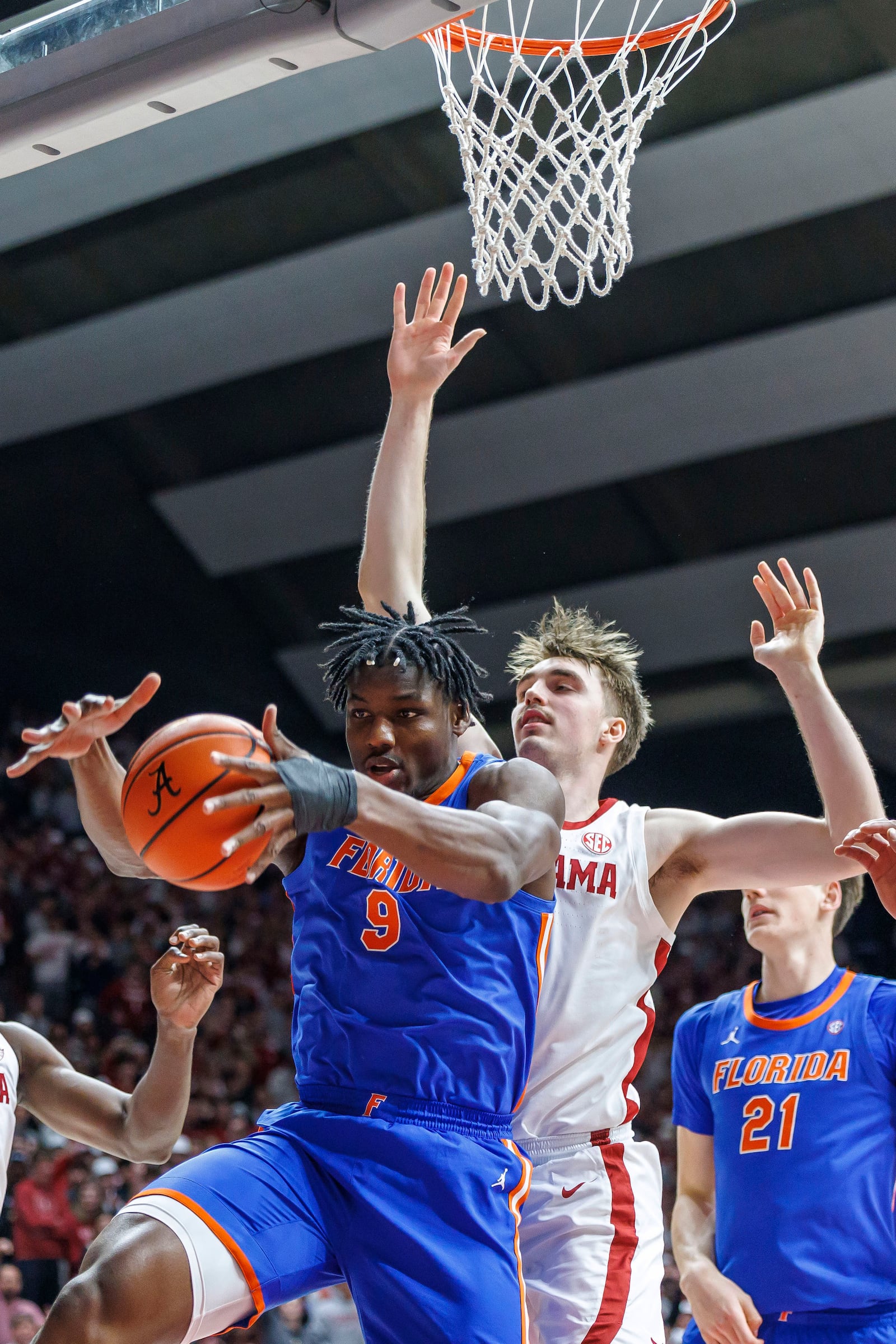 Florida center Rueben Chinyelu (9) rebounds the ball in front of Alabama forward Grant Nelson during the first half of an NCAA college basketball game, Wednesday, March 5, 2025, in Tuscaloosa, Ala. (AP Photo/Vasha Hunt)