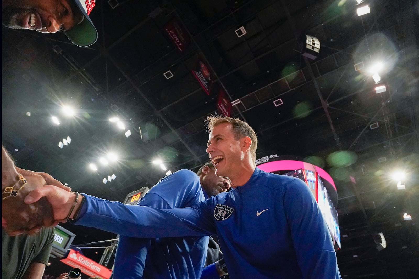 Duke head coach Jon Scheyer shakes hands with former NBA star Gilbert Arenas at the end of an NCAA college basketball game against Arizona, Friday, Nov. 22, 2024, in Tucson, Ariz. (AP Photo/Darryl Webb)