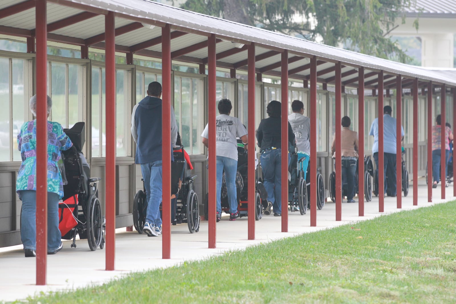 Residents of the Stillwater Center use a new walkway to get from the center to Northview School. Before, many of the residents were traveling about 11 miles by bus for services. CHRIS STEWART / STAFF