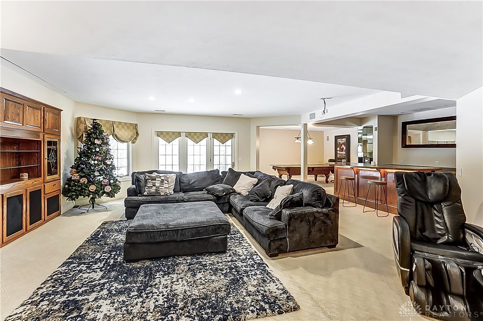 The finished lower level has a recreation/family room with fireplace, game room, exercise room, wet bar and sauna as well as an additional bedroom and full bath.