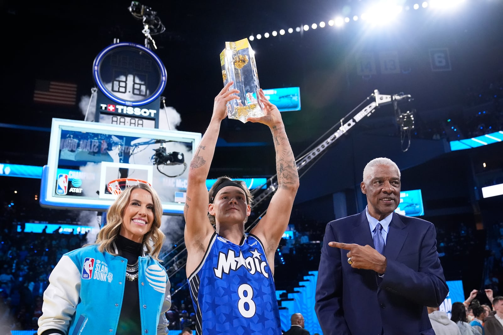 Orlando Magic guard Mac McClung, center, celebrates with Julius Erving, right, after winning the slam dunk contest at the NBA basketball All-Star Saturday night festivities Saturday, Feb. 15, 2025, in San Francisco. (AP Photo/Godofredo A. Vásquez)